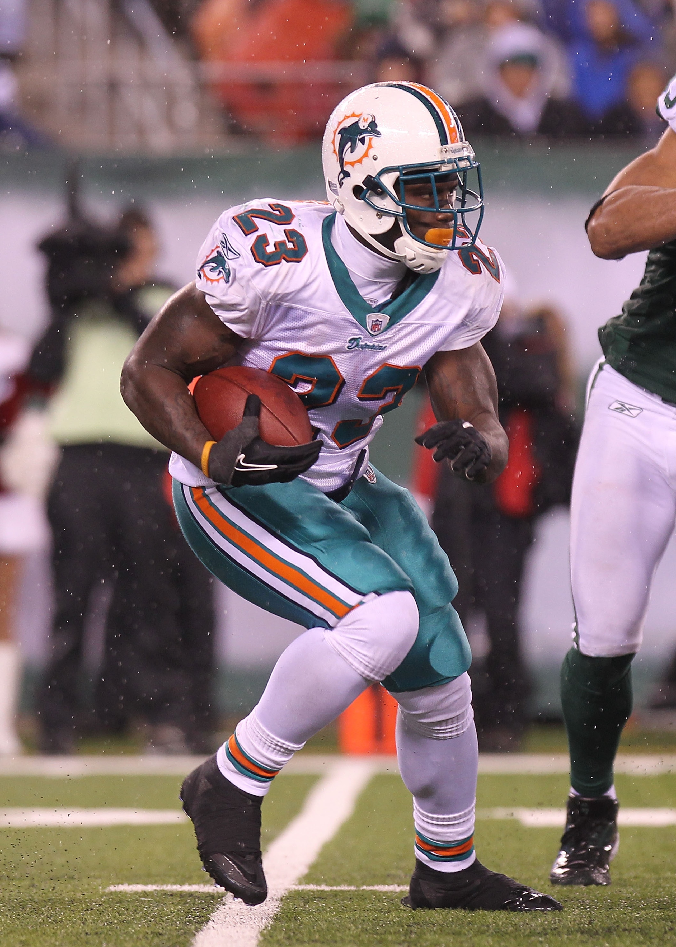 EAST RUTHERFORD, NJ - DECEMBER 12:  Ronnie Brown #23 of the Miami Dolphins rushes against the New York Jets at New Meadowlands Stadium on December 12, 2010 in East Rutherford, New Jersey.  (Photo by Nick Laham/Getty Images)