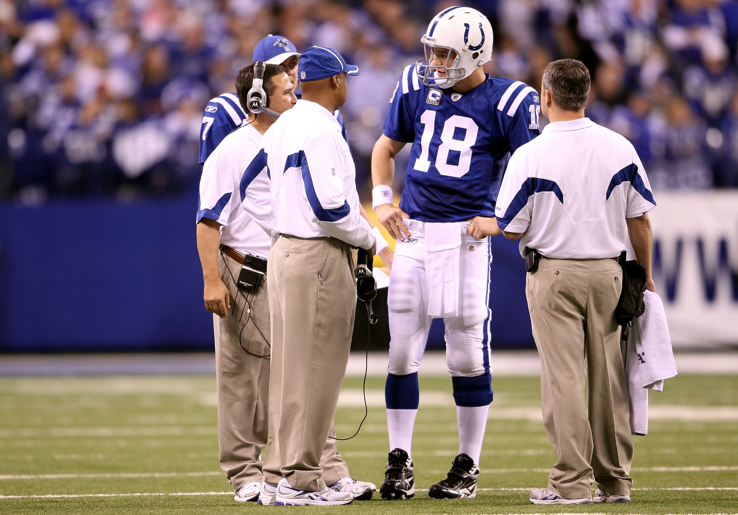 INDIANAPOLIS, IN - JANUARY 08:  Quarterback Peyton Manning #18 of the Indianapolis Colts talks with head coach Jim Caldwell against the New York Jets during their 2011 AFC wild card playoff game at Lucas Oil Stadium on January 8, 2011 in Indianapolis, Ind