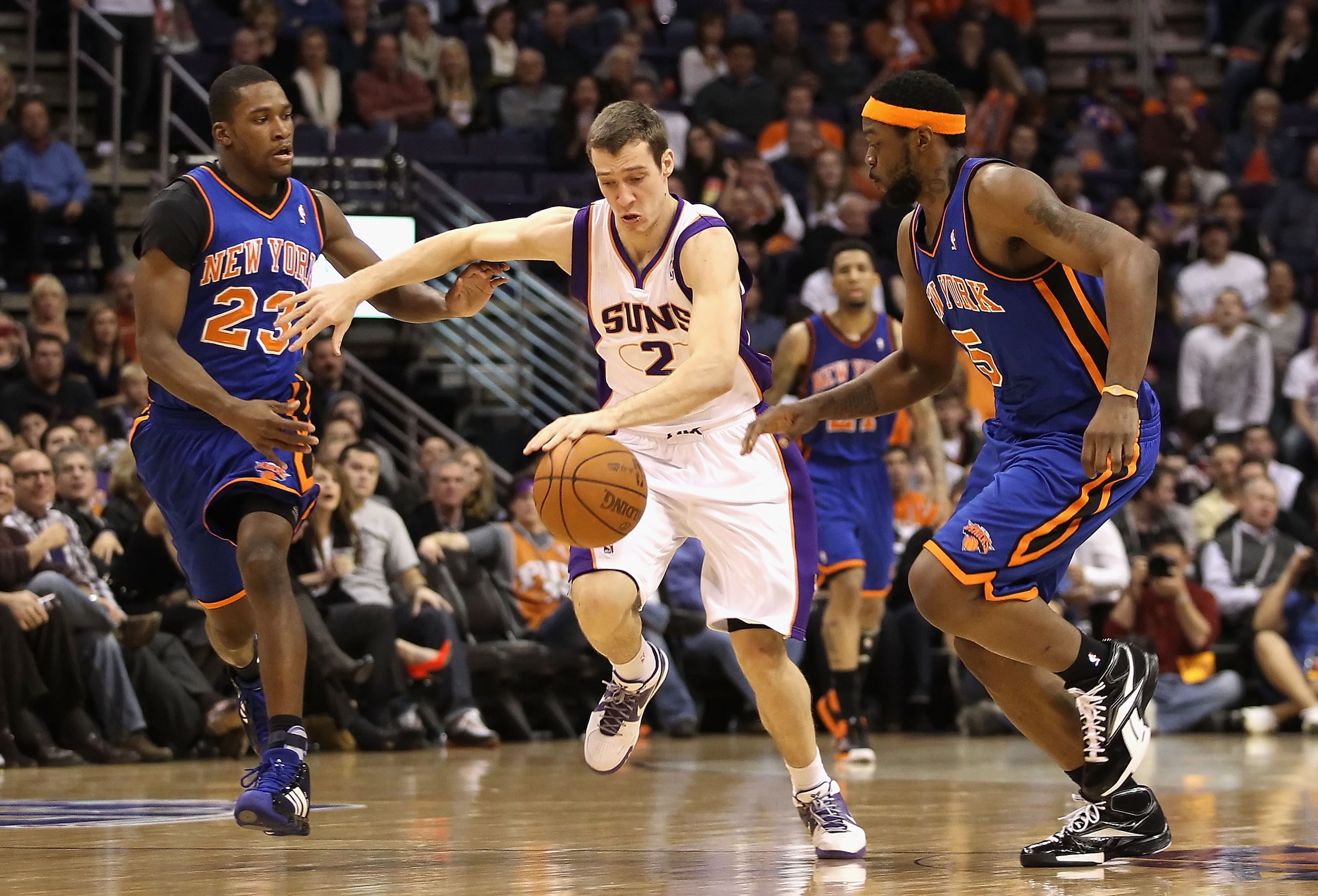 PHOENIX - JANUARY 07:  Goran Dragic #2 of the Phoenix Suns drives the ball upcourt past Toney Douglas #23 and Bill Walker #5 of the New York Knicks during the NBA game at US Airways Center on January 7, 2011 in Phoenix, Arizona.  The Knicks defeated the S