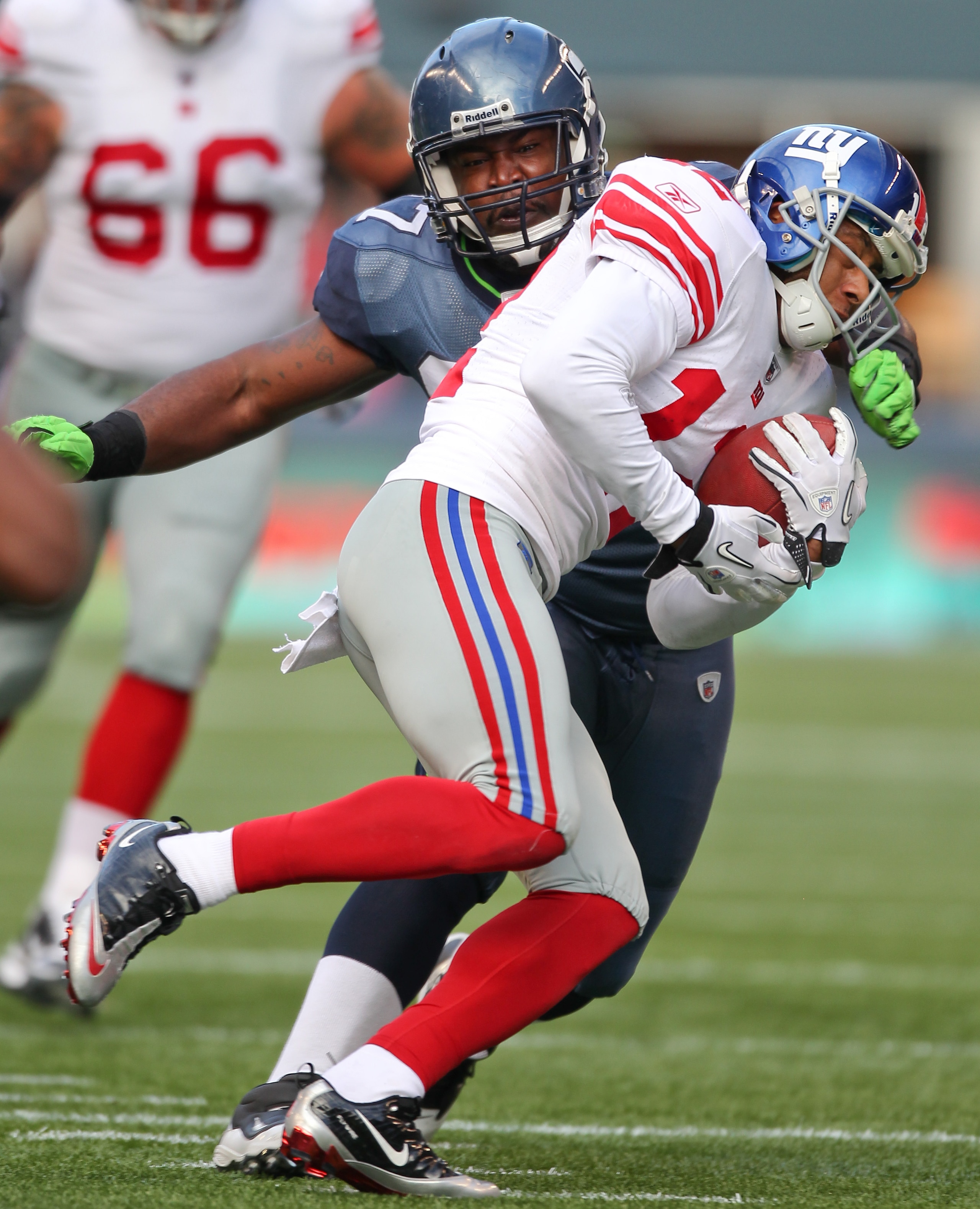 SEATTLE - NOVEMBER 07:  Defensive tackle E.J. Wilson #97 of the Seattle Seahawks tackles Steve Smith #12 of the New York Giants at Qwest Field on November 7, 2010 in Seattle, Washington. The Giants defeated the Seahawks 41-7. (Photo by Otto Greule Jr/Gett