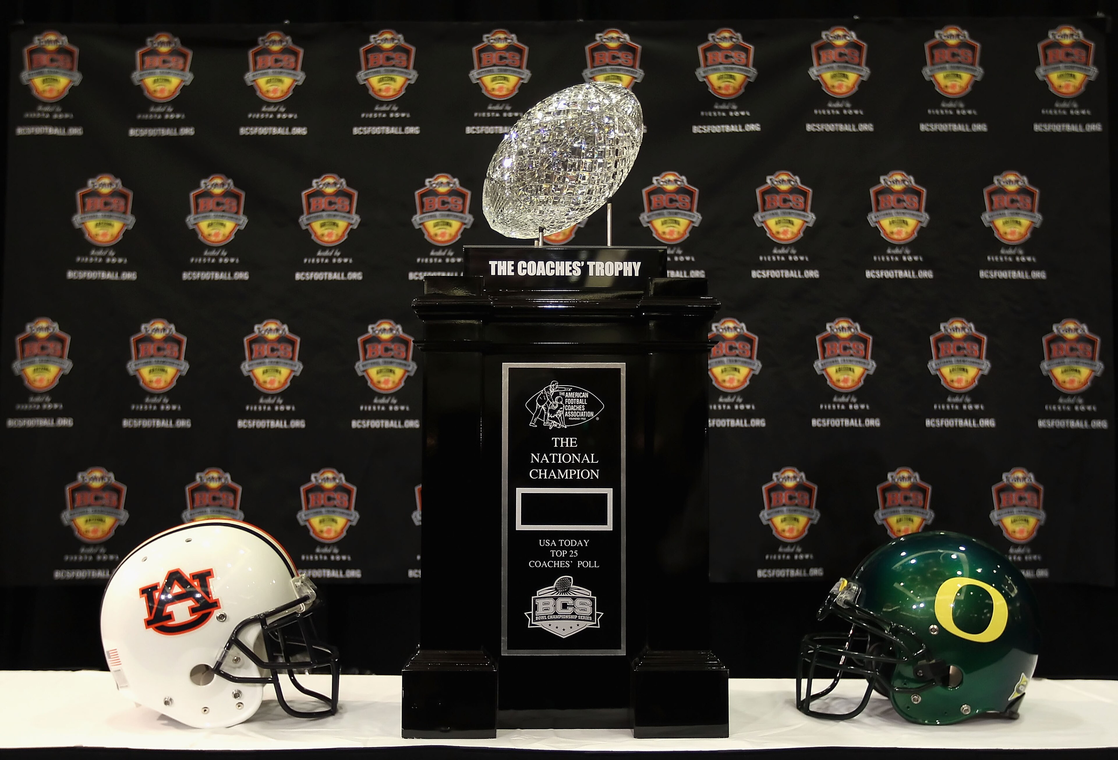 SCOTTSDALE, AZ - JANUARY 07: The coaches trophy is displayed with helmets for the Auburn Tigers and the Oregon Ducks during Media Day for the Tostitos BCS National Championship Game at the JW Marriott Camelback Inn on January 7, 2011 in Scottsdale, Arizo SCOTTSDALE, AZ - JANUARY 07: The coaches trophy is displayed with helmets for the Auburn Tigers and the Oregon Ducks during Media Day for the Tostitos BCS National Championship Game at the JW Marriott Camelback Inn on January 7, 2011 in Scottsdale, Arizo