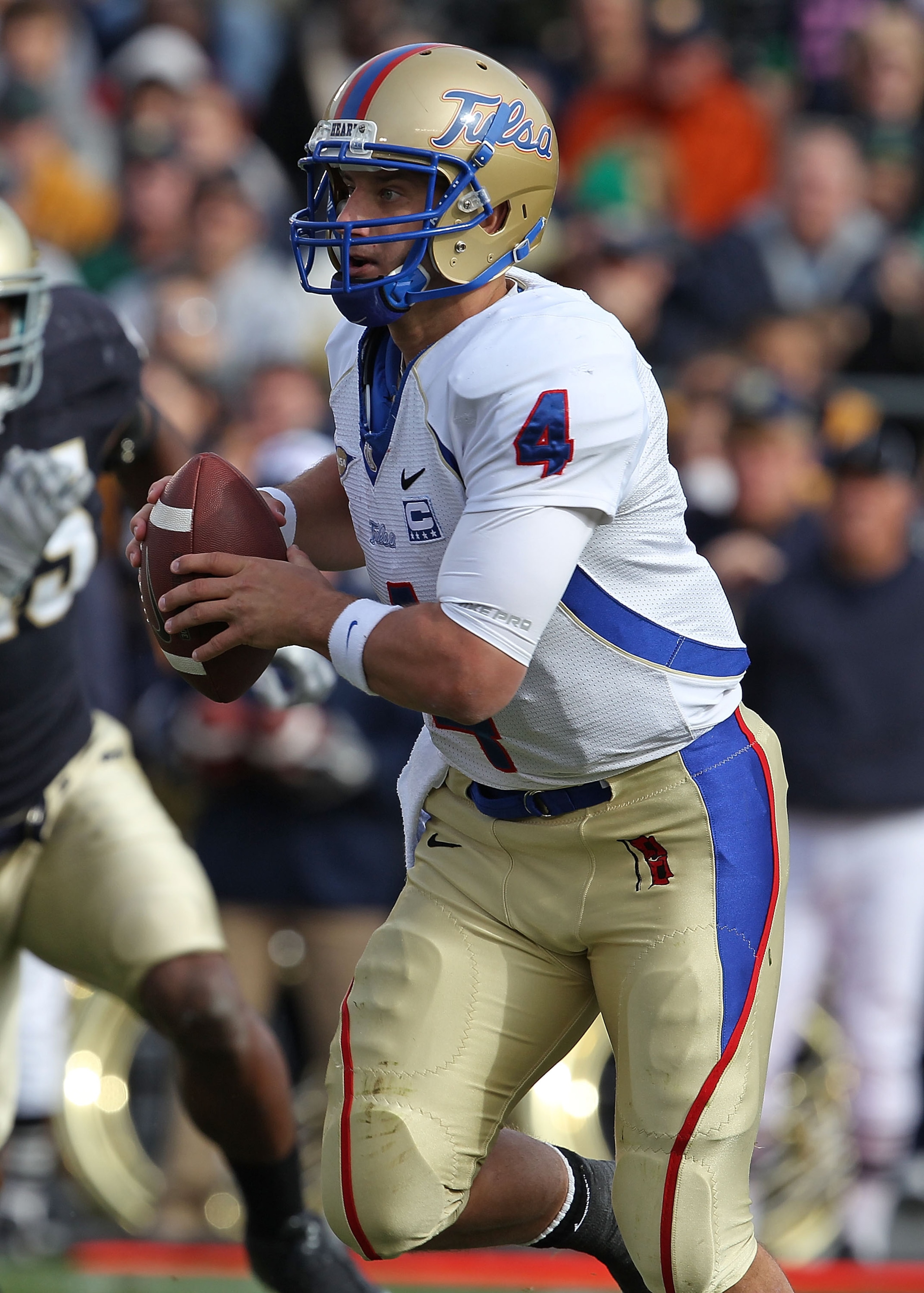 SOUTH BEND, IN - OCTOBER 30: G.J. Kinne #4 of the Tulsa Golden Hurricane rolls out to look for a receiver against the Notre Dame Fighting Irish at Notre Dame Stadium on October 30, 2010 in South Bend, Indiana. Tulsa defeated Notre Dame 28-27. (Photo by Jo