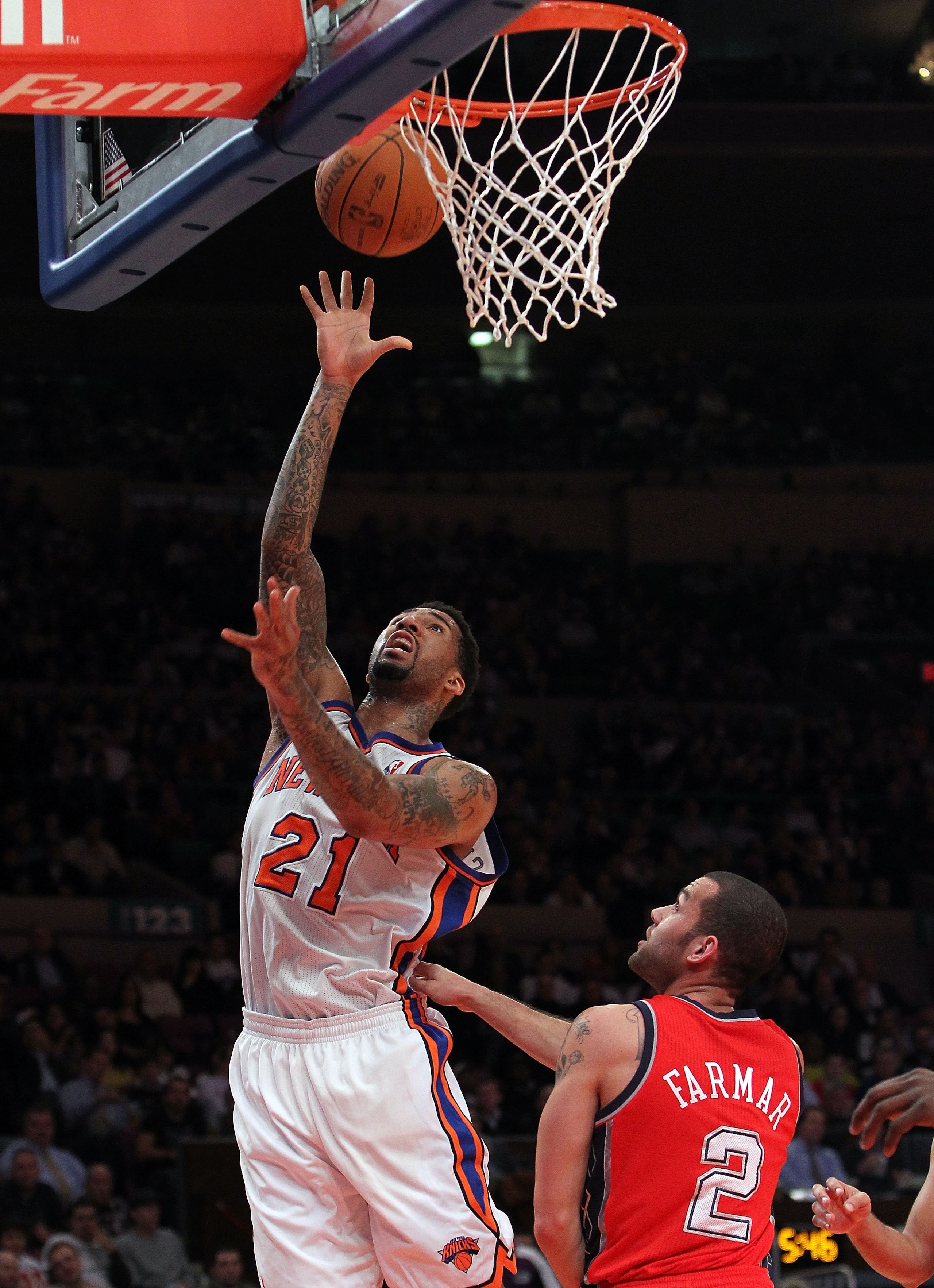 NEW YORK, NY - NOVEMBER 30:  Wilson Chandler #21 of the New York Knicks shoots the ball over Jordan Farmer #2 of the New Jersey Nets on November 30, 2010 at Madison Square Garden in New York City. NOTE TO USER: User expressly acknowledges and agrees that,