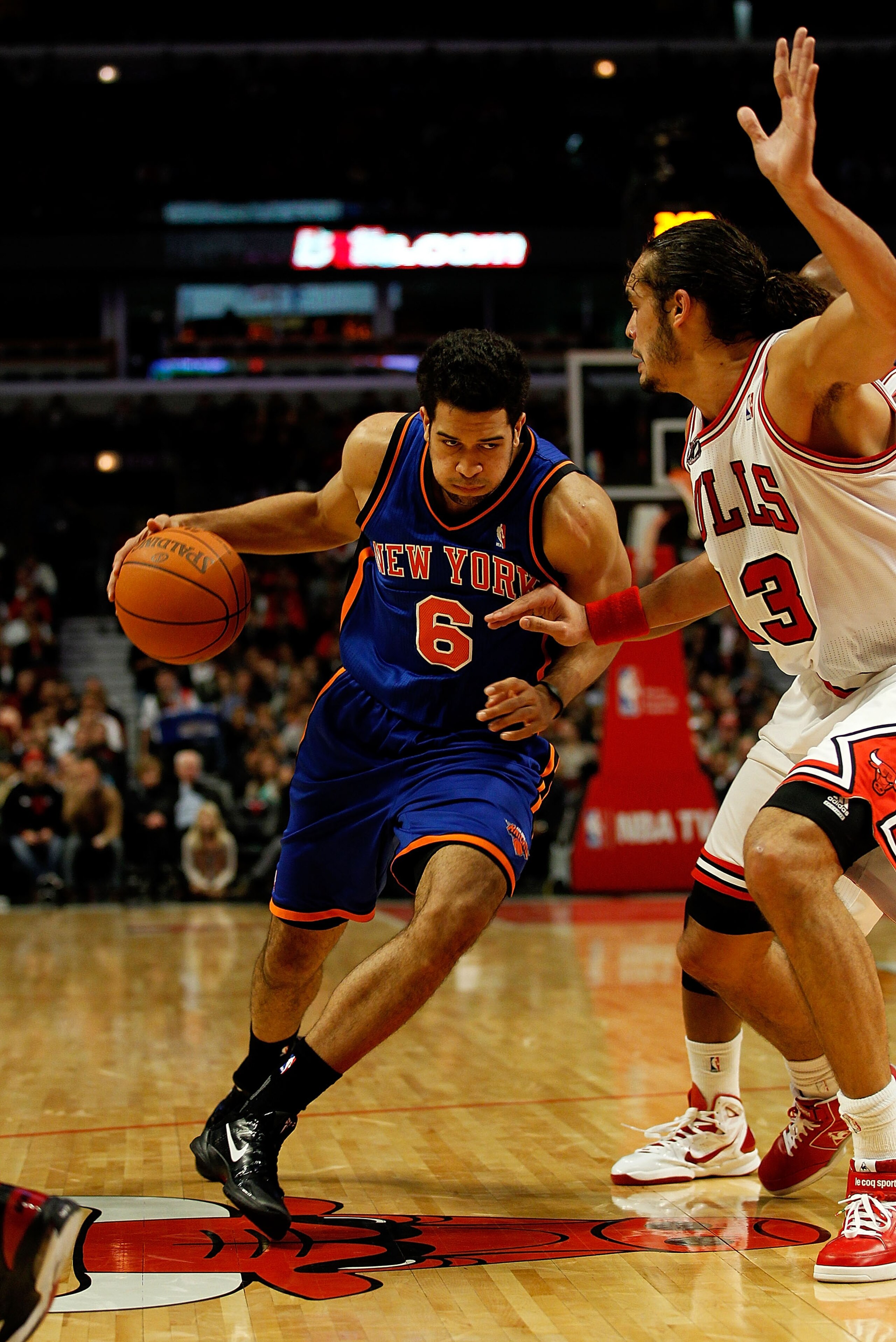CHICAGO - NOVEMBER 04: Landry Fields #6 of the New York Knicks drives against Joakim Noah #13 of the Chicago Bulls at the United Center on November 4, 2010 in Chicago, Illinois. The Knicks defeated the Bulls 120-112. NOTE TO USER: User expressly acknowled