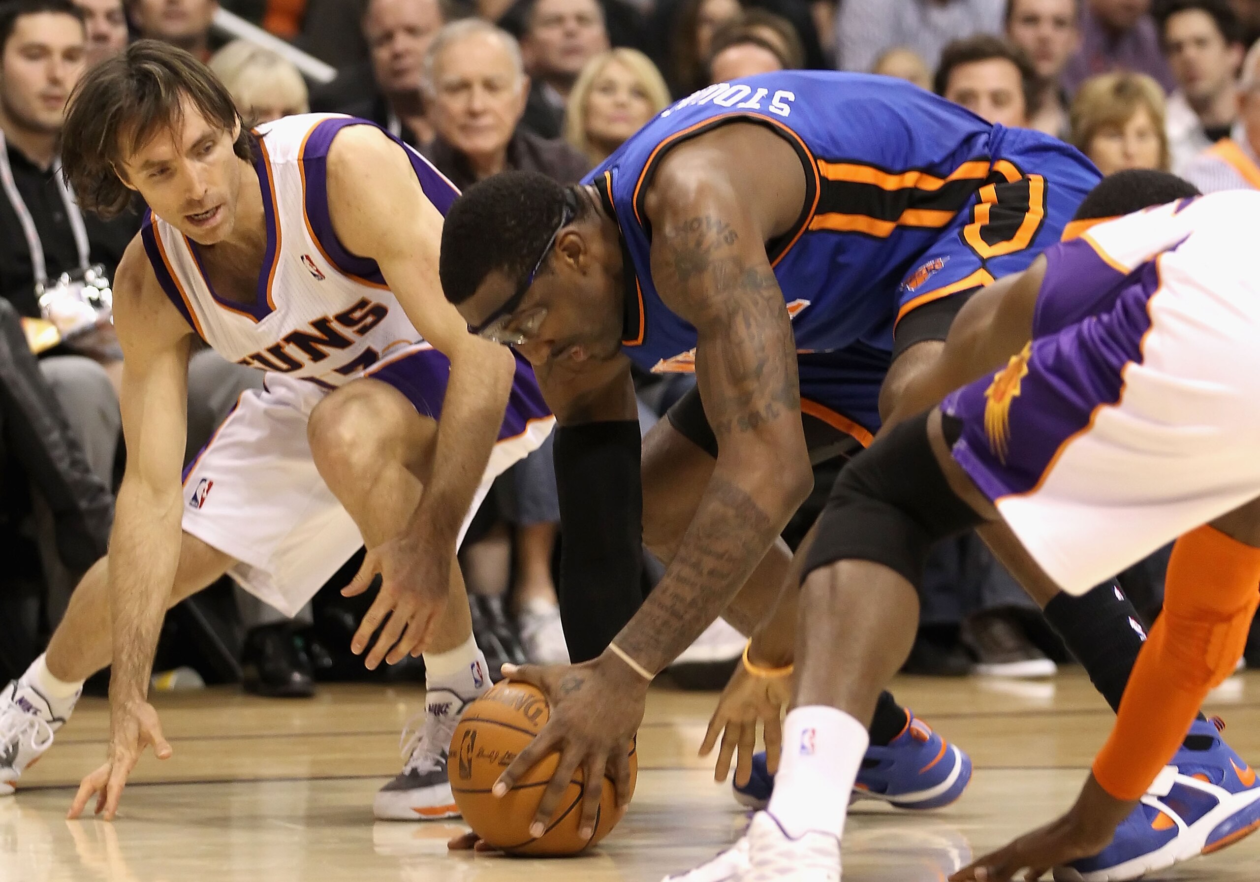 PHOENIX - JANUARY 07:  Steve Nash #13 of the Phoenix Suns battles for a loose ball with Amar'e Stoudemire #1 of the New York Knicks during the NBA game at US Airways Center on January 7, 2011 in Phoenix, Arizona.  The Knicks defeated the Suns 121-96.  NOT