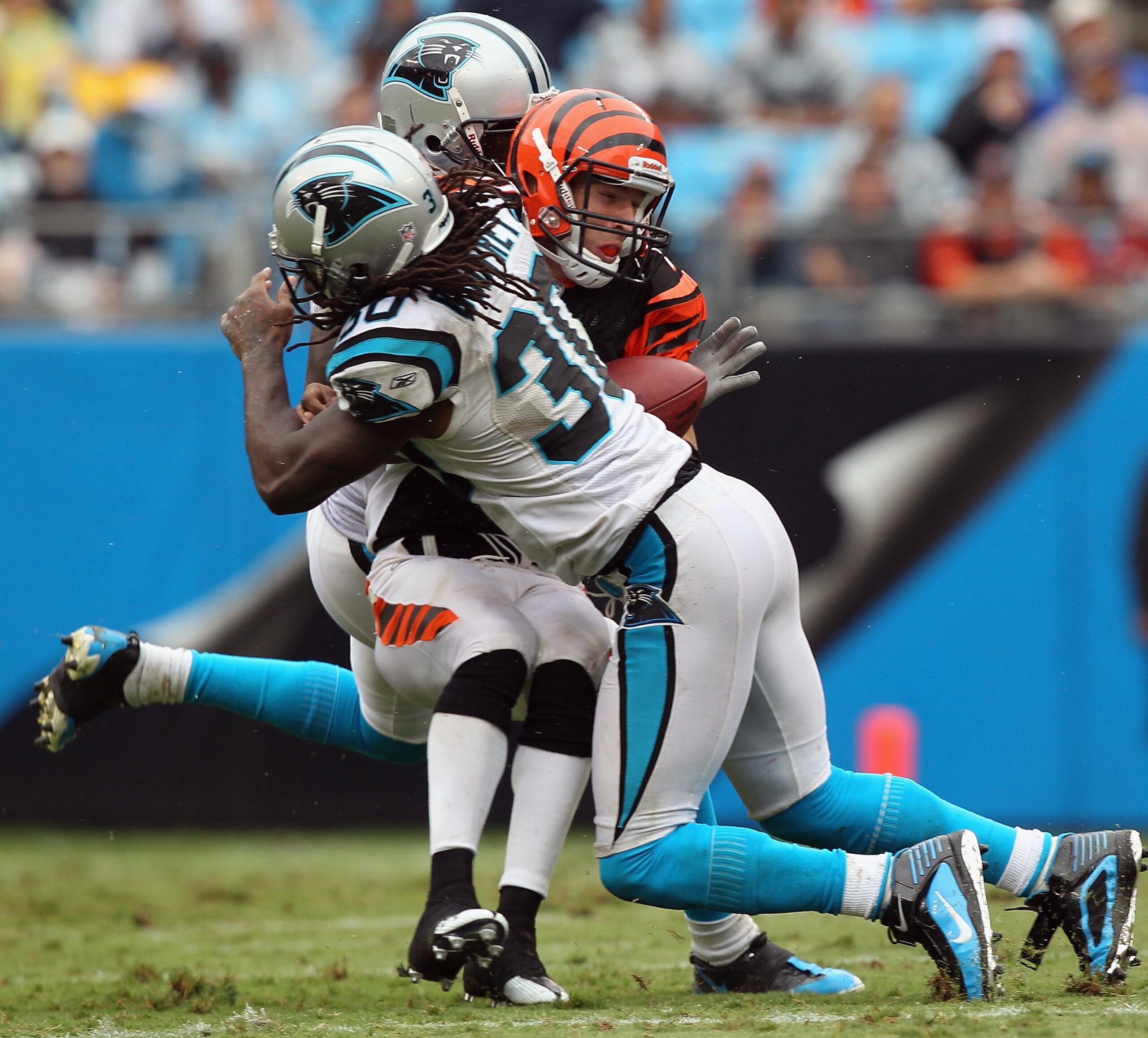 CHARLOTTE, NC - SEPTEMBER 26: Jordan Shipley #11 of the Cincinnati Bengals is tackled by teammates Chris Gamble #20 and Charles Godfrey #30 of the Carolina Panthers during their game at Bank of America Stadium on September 26, 2010 in Charlotte, North Ca CHARLOTTE, NC - SEPTEMBER 26: Jordan Shipley #11 of the Cincinnati Bengals is tackled by teammates Chris Gamble #20 and Charles Godfrey #30 of the Carolina Panthers during their game at Bank of America Stadium on September 26, 2010 in Charlotte, North Ca
