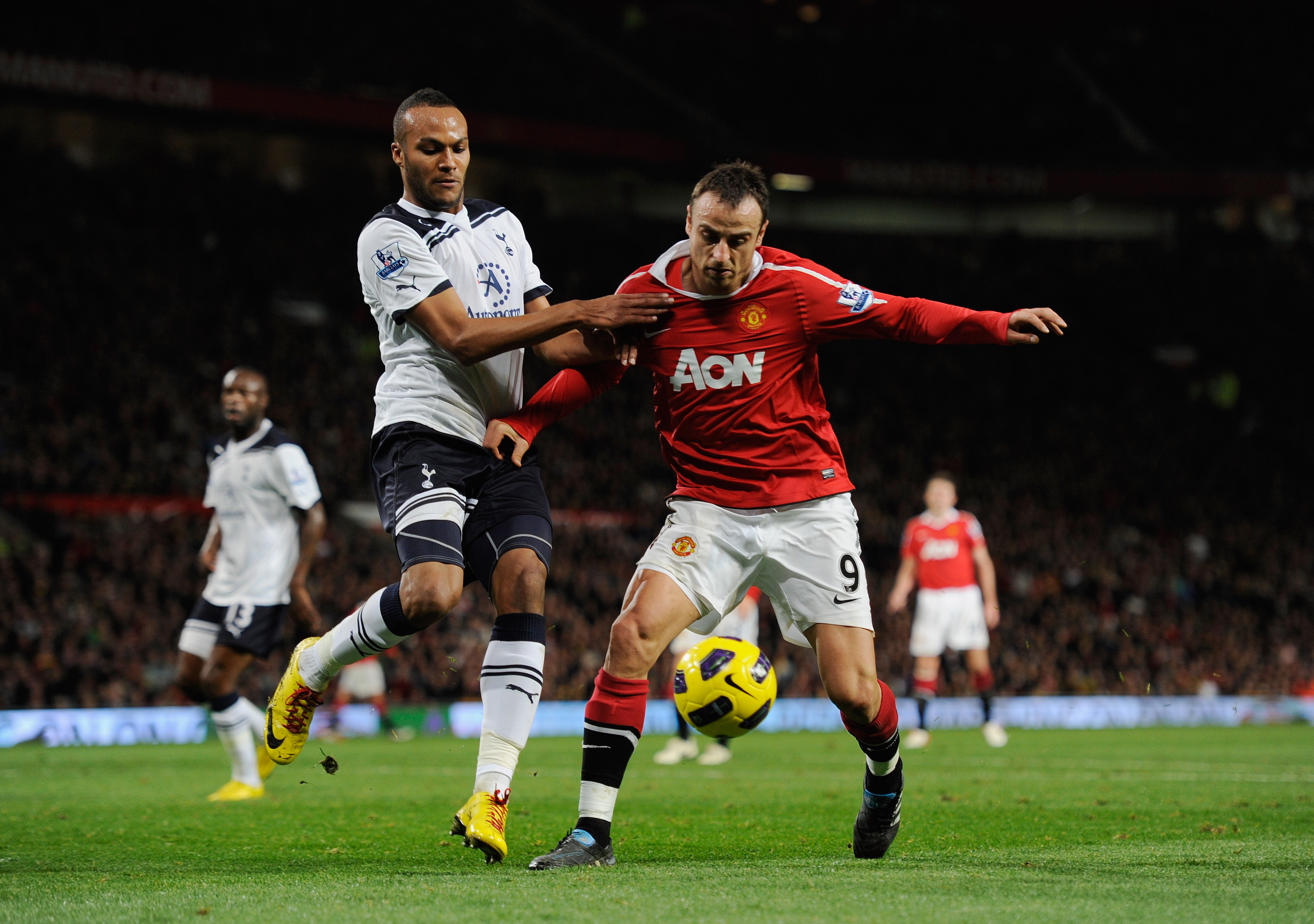 MANCHESTER, ENGLAND - OCTOBER 30: Dimitar Berbatov of Manchester United is challenged by Younes Kaboul of Tottenham during the Barclays Premier League match between Manchester United and Tottenham Hotspur at Old Trafford on October 30, 2010 in Manchester,