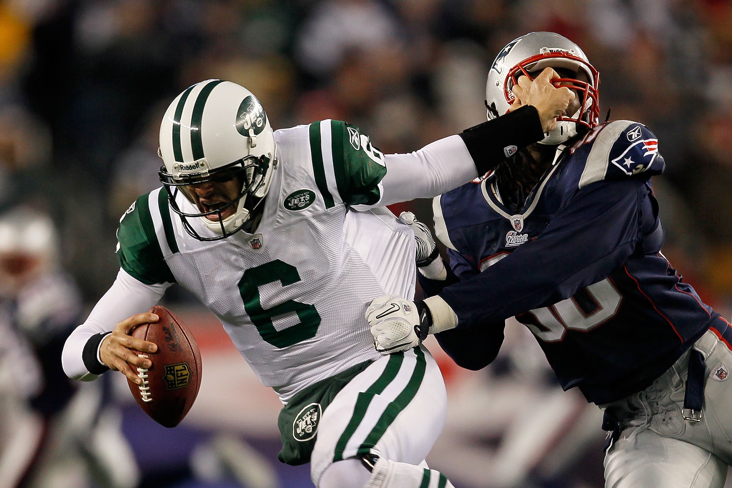 FOXBORO, MA - DECEMBER 06:  Mark Sanchez #6 of the New York Jets attempts to escape the pass rush of Jermaine Cunningham #96 of the New England Patriots at Gillette Stadium on December 6, 2010 in Foxboro, Massachusetts.  (Photo by Jim Rogash/Getty Images)