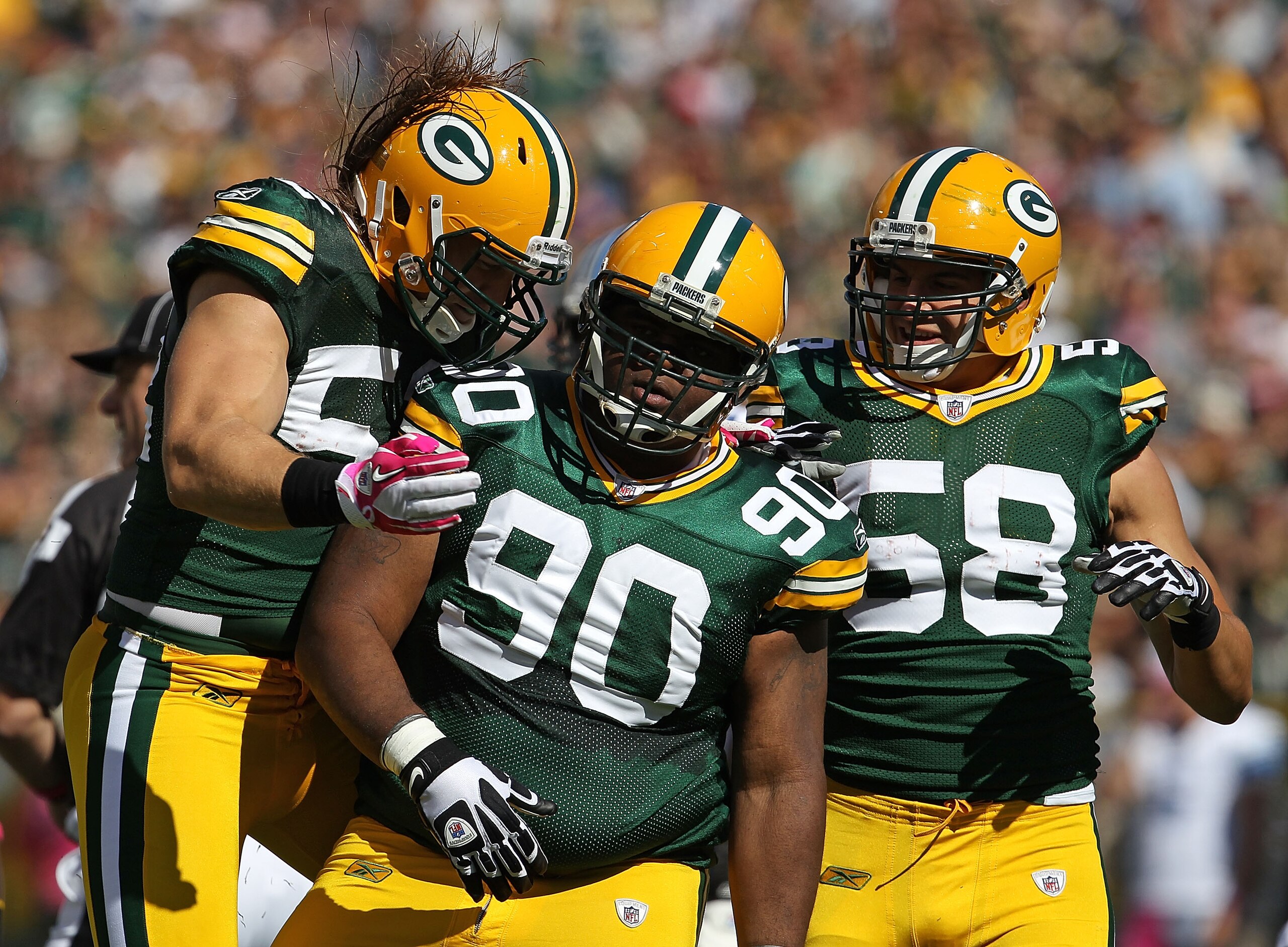 GREEN BAY, WI - OCTOBER 03: A.J. Hawk #50, B.J. Raji #90 and Frank Zombo #58 of the Green Bay Packers celebrates a defensive stop against the Detroit Lions at Lambeau Field on October 3, 2010 in Green Bay, Wisconsin. The Packers defeated the Lions 28-26.