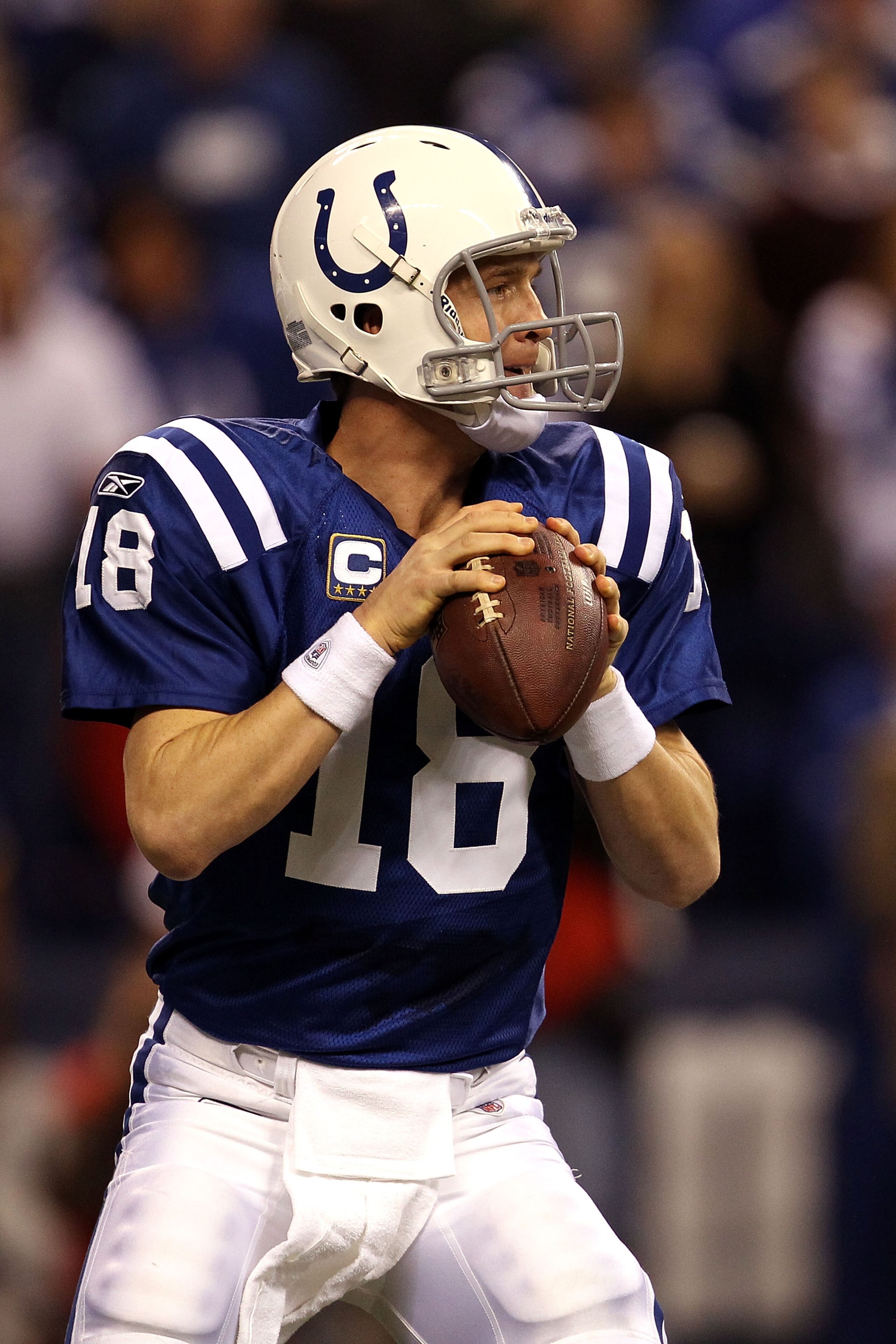 INDIANAPOLIS, IN - JANUARY 08:  Quarterback Peyton Manning #18 of the Indianapolis Colts looks to pass against the New York Jets during their 2011 AFC wild card playoff game at Lucas Oil Stadium on January 8, 2011 in Indianapolis, Indiana. The Jets won 17