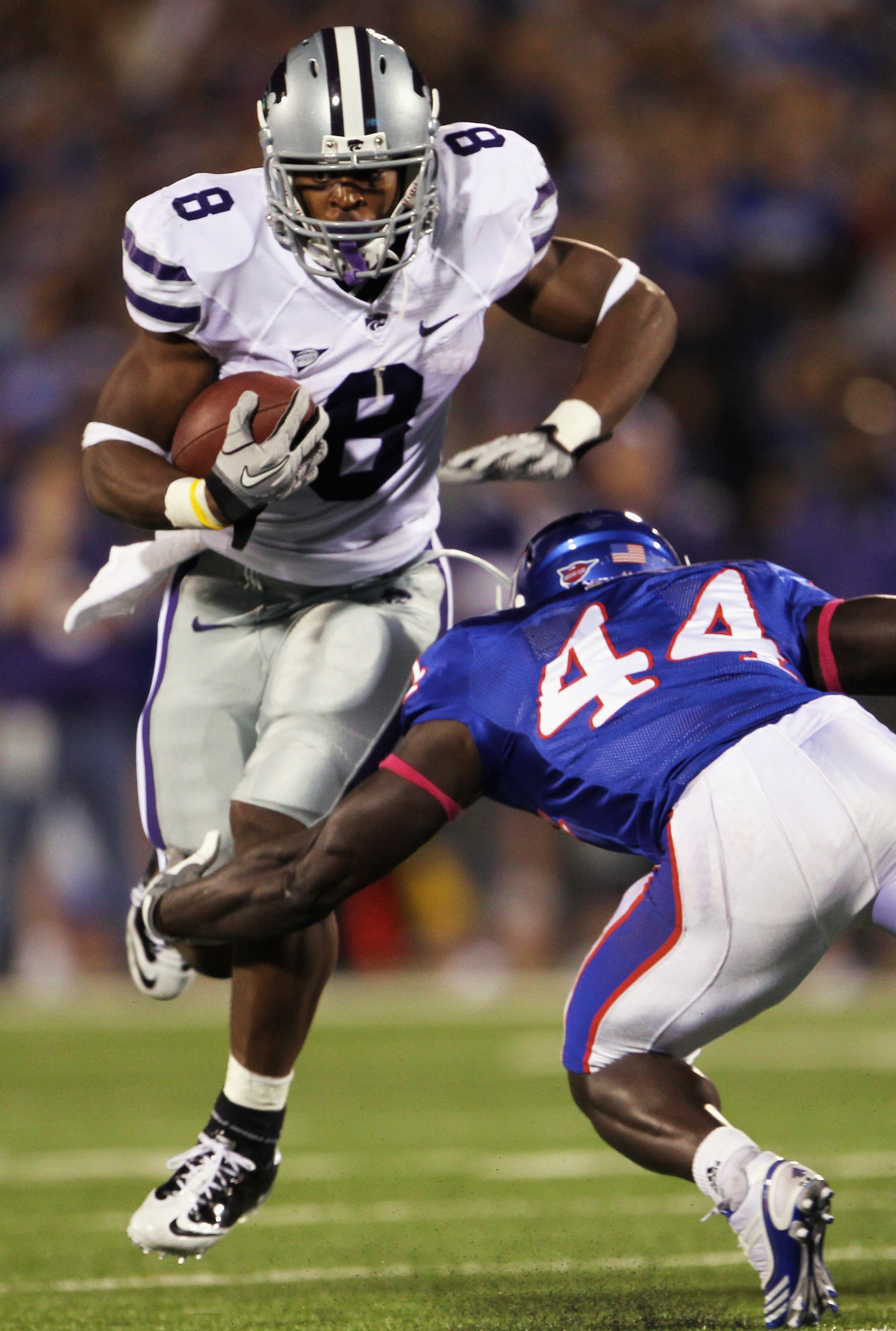 LAWRENCE, KS - OCTOBER 14: Daniel Thomas #8 of the Kansas State Wildcats carries the ball as Olaitan Oguntodu #44 of the Kansas Jayhawks defends during the game on October 14, 2010 at Memorial Stadium in Lawrence, Kansas. (Photo by Jamie Squire/Getty Im LAWRENCE, KS - OCTOBER 14: Daniel Thomas #8 of the Kansas State Wildcats carries the ball as Olaitan Oguntodu #44 of the Kansas Jayhawks defends during the game on October 14, 2010 at Memorial Stadium in Lawrence, Kansas. (Photo by Jamie Squire/Getty Im
