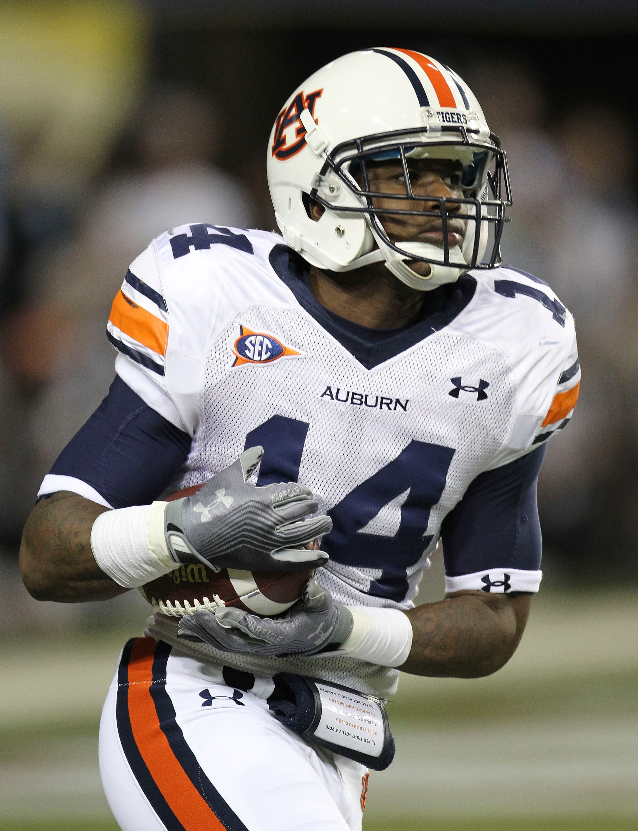 ATLANTA - DECEMBER 4:  Kick returner Demond Washington #14 of the Auburn Tigers runs with the ball after a kickoff during the 2010 SEC Championship against the South Carolina Gamecocks at Georgia Dome on December 4, 2010 in Atlanta, Georgia. (Photo by Mik