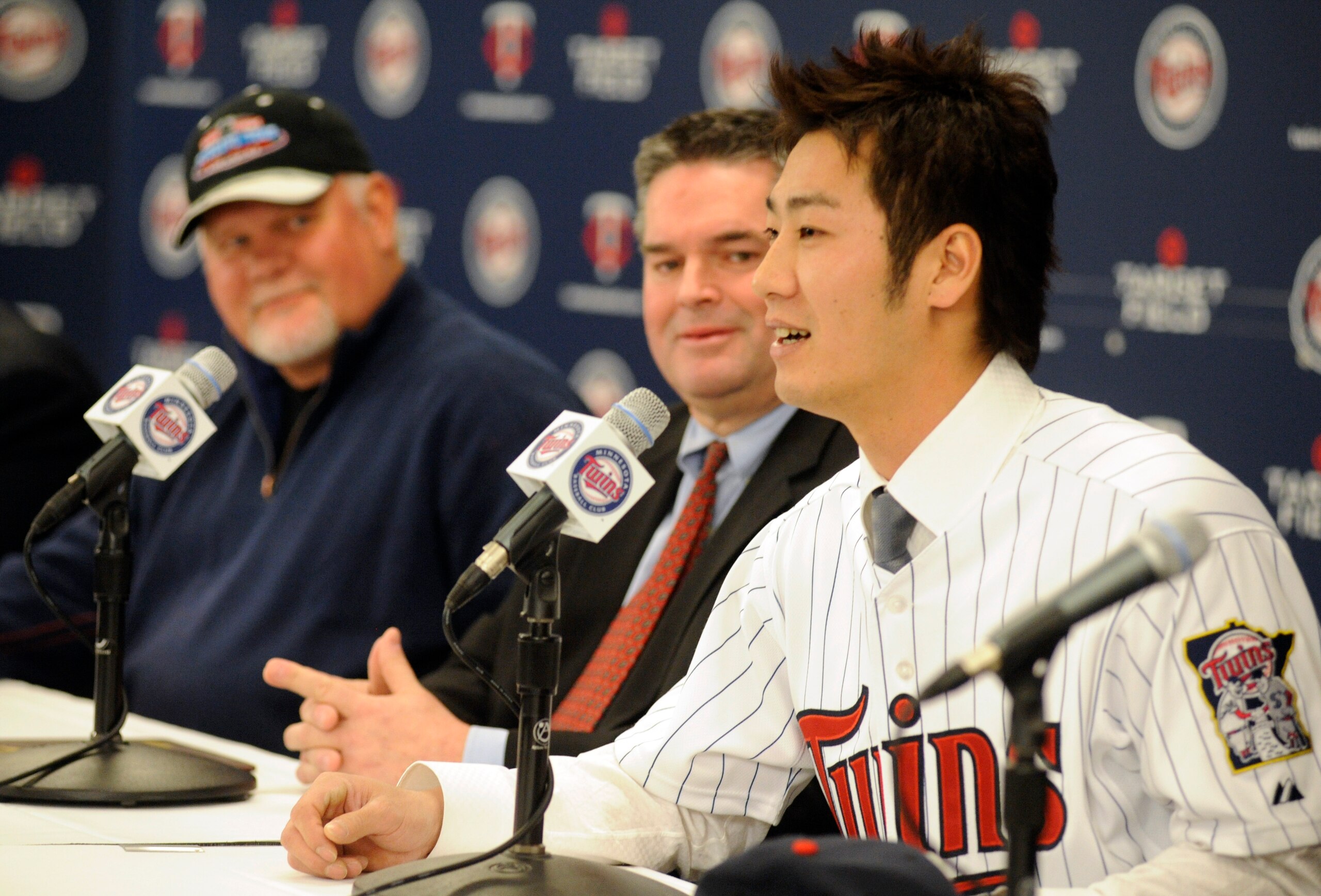 MINNEAPOLIS, MN - DECEMBER 18: Tsuyoshi Nishioka #1 of the Minnesota Twins speaks to members of the media as manager Ron Gardenhire (L) and general manager Bill Smith (C) look on during a press conference December 18, 2010 at Target Field in Minneapolis,