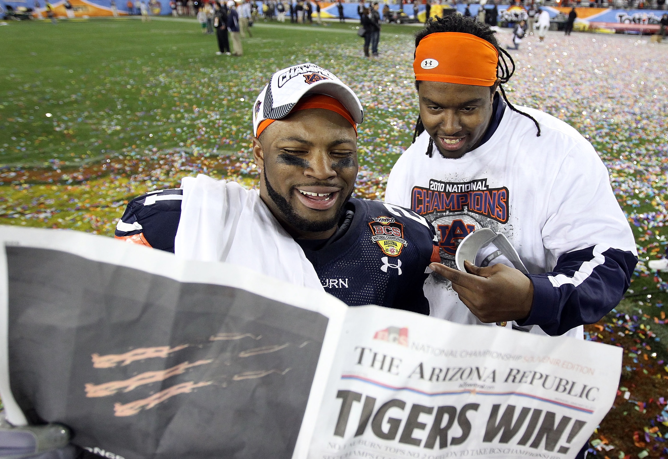 GLENDALE, AZ - JANUARY 10: Auburn Tigers tigers players read the Arizona Republic after the Tigers defeated the Oregon Ducks 22-19 during the Tostitos BCS National Championship Game at University of Phoenix Stadium on January 10, 2011 in Glendale, Arizon GLENDALE, AZ - JANUARY 10: Auburn Tigers tigers players read the Arizona Republic after the Tigers defeated the Oregon Ducks 22-19 during the Tostitos BCS National Championship Game at University of Phoenix Stadium on January 10, 2011 in Glendale, Arizon