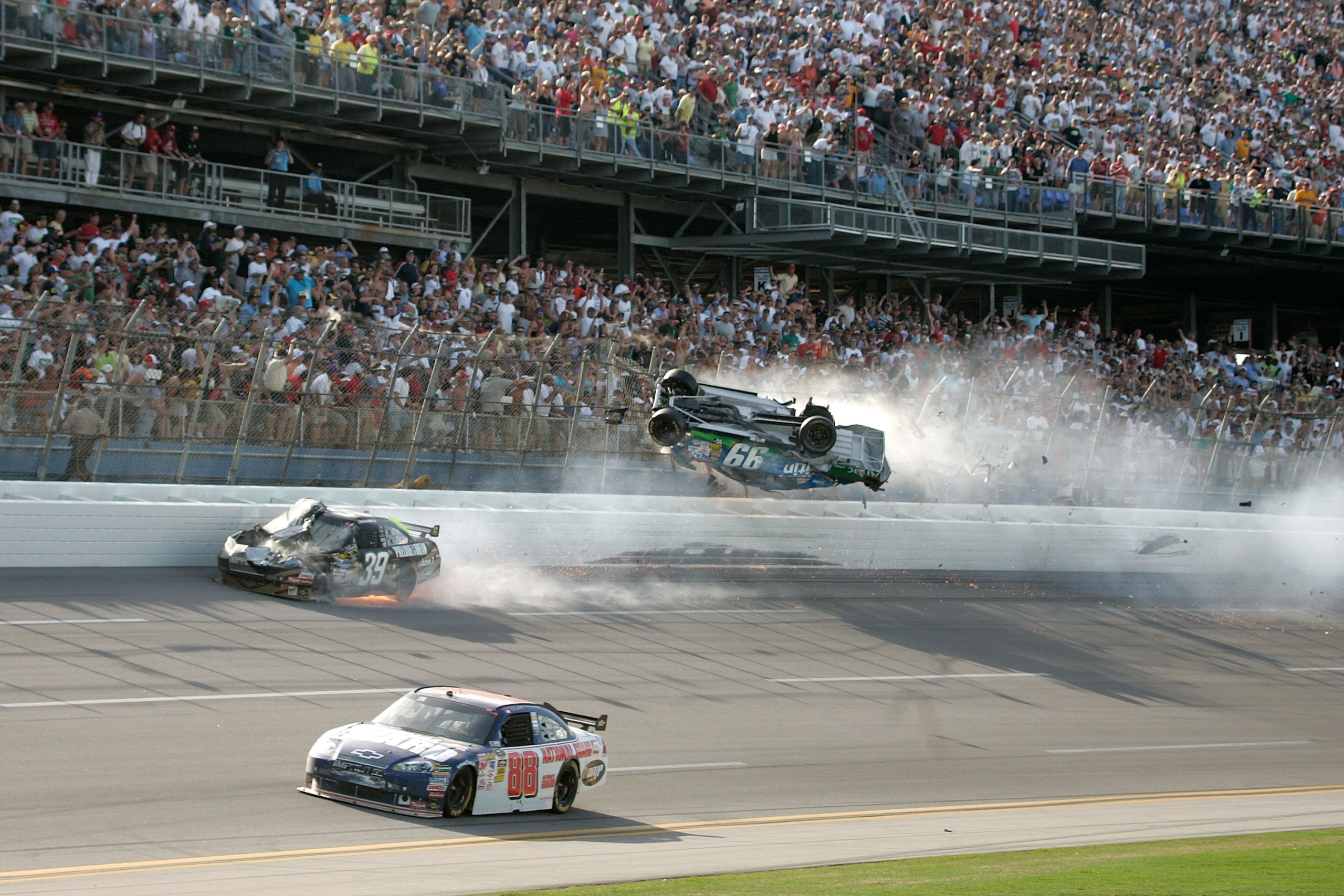 TALLADEGA, AL - APRIL 26:  Carl Edwards, driver of the #99 Claritin Ford, goes airborne as Ryan Newman, driver of the #39 Steweart-Haas Racing Chevrolet suffers damage and Dale Earnhardt Jr., driver of the #88 National Guard / AMP Energy Chevrolet drives
