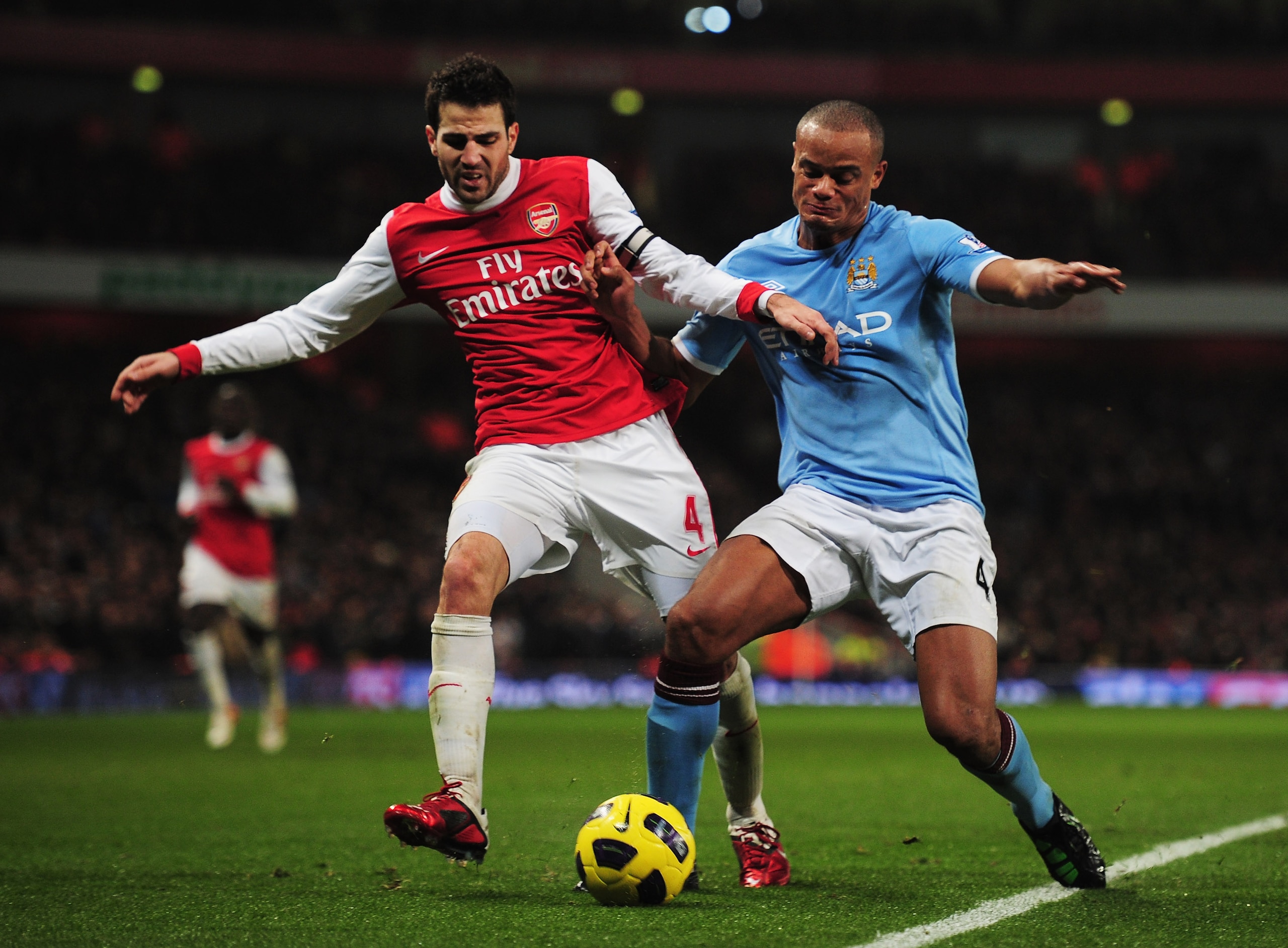 LONDON, ENGLAND - JANUARY 05:  Cesc Fabregas of Arsenal battles with Vincent Kompany of Manchester City during the Barclays Premier League match between Arsenal and Manchester City at the Emirates Stadium on January 5, 2011 in London, England.  (Photo by
