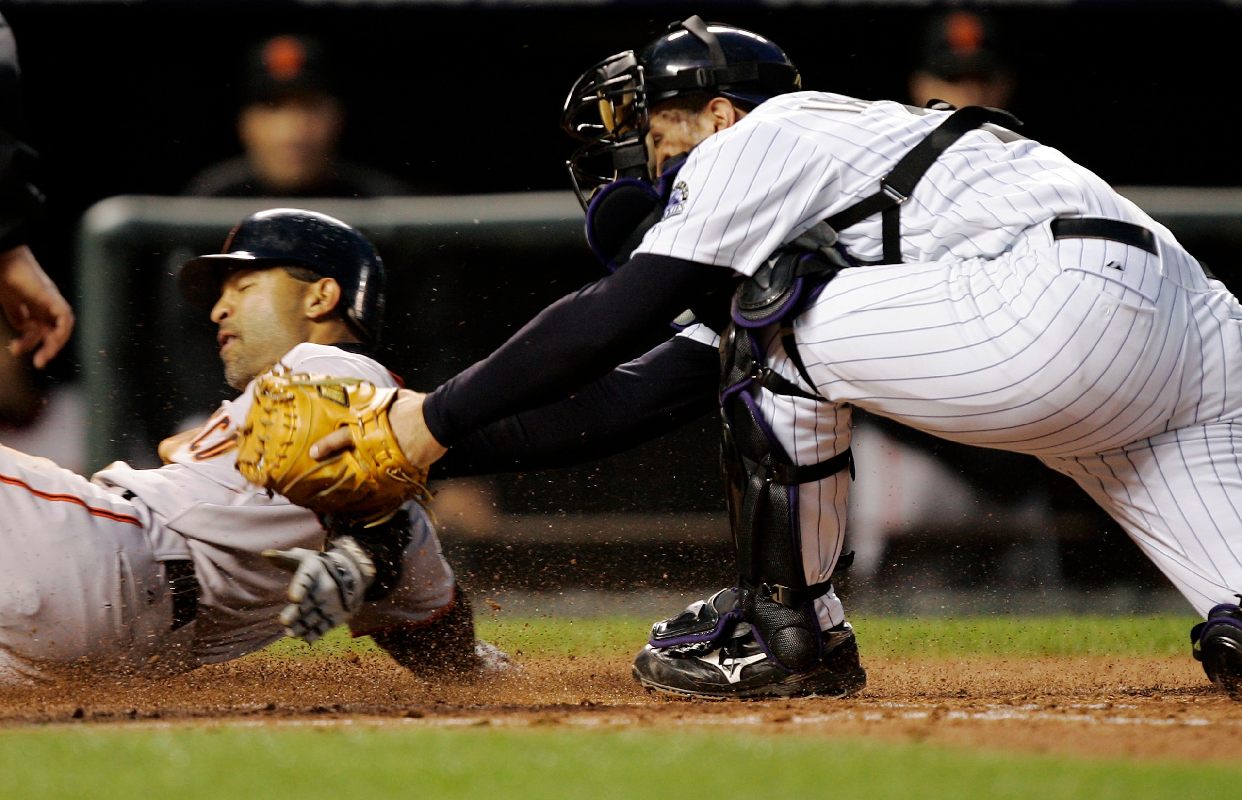 DENVER - APRIL 16:  Dave Roberts #10 of the San Francisco Giants slides safely past catcher Chris Iannetta #20 of the Colorado Rockies on a sacrifice fly by Rich Aurilia in the fourth inning on April 16, 2007 at Coors Field in Denver, Colorado.  (Photo by