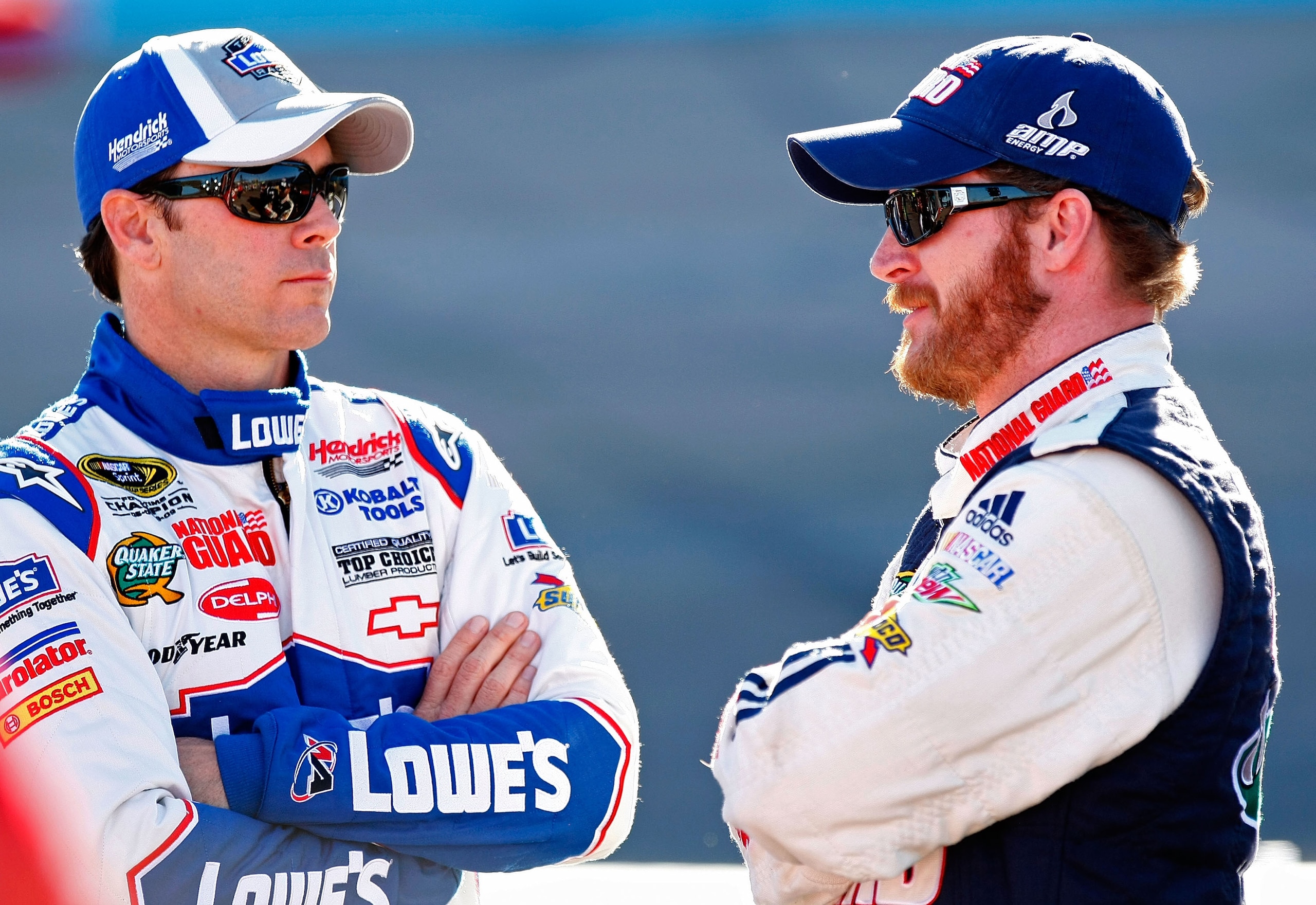 PHOENIX - APRIL 09: Jimmie Johnson (L), driver of the #48 Lowe's Chevrolet, talks with Dale Earnhardt Jr. (R), driver of the #88 National Guard/AMP Energy Chevrolet, during qualifying for the NASCAR Sprint Cup Series Subway Fresh Fit 600 at Phoenix Intern