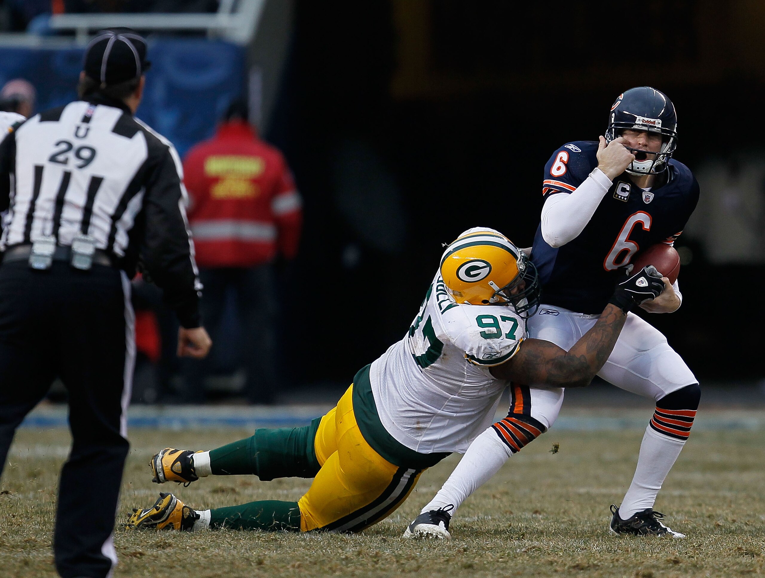 CHICAGO - DECEMBER 13: Jay Cutler #6 of the Chicago Bears complains to umpire Steve Wilson #29 that he was grabbed by the facemask by Johnny Jolly #97 of the Green Bay Packers at Soldier Field on December 13, 2009 in Chicago, Illinois. The Packers defeate