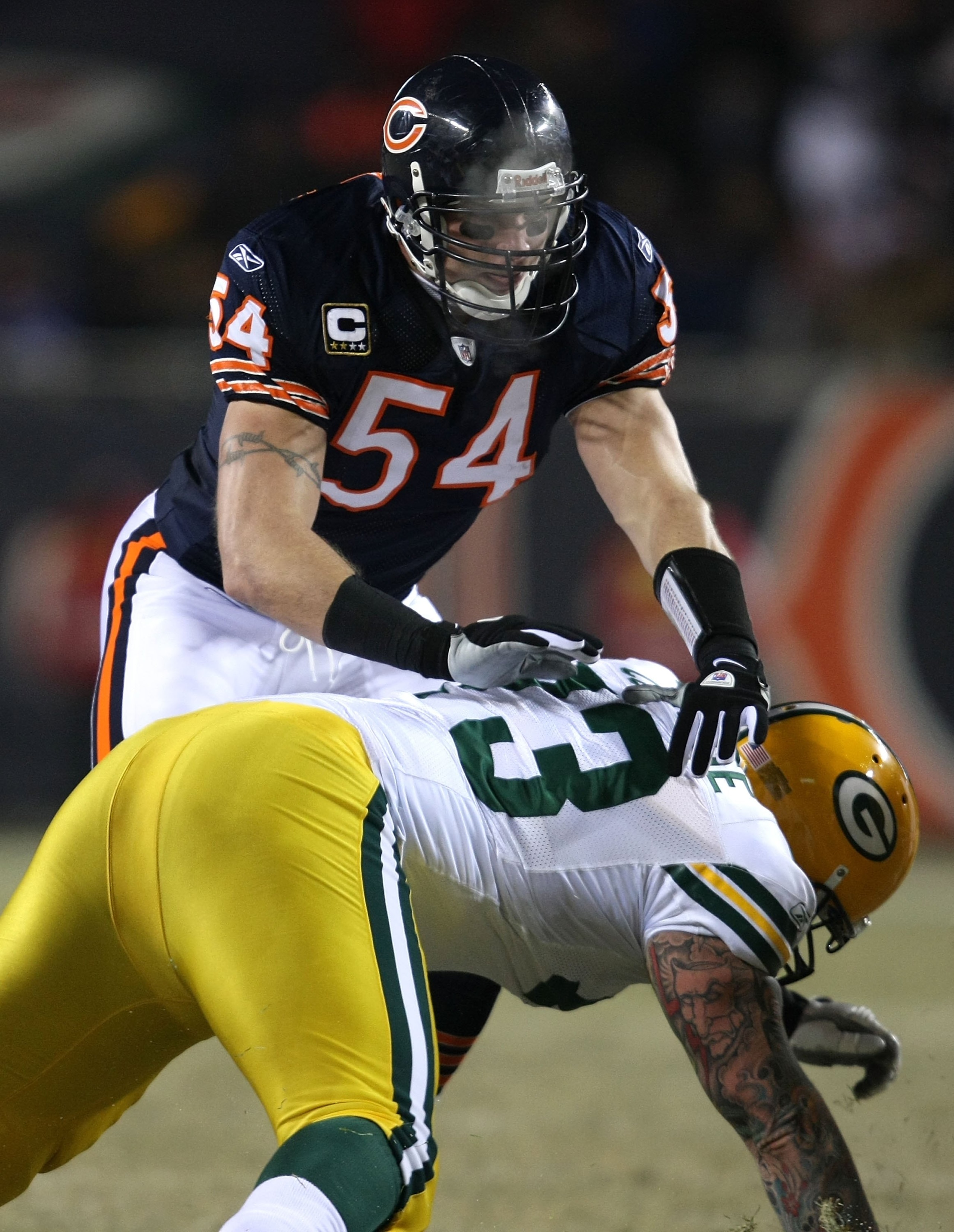 CHICAGO - DECEMBER 22: Brian Urlacher #54 of the Chicago Bears sheds a block by Daryn Colledge #73 of the Green Bay Packers on December 22, 2008 at Soldier Field in Chicago, Illinois. The Bears defeated the Packers 20-17 in overtime. (Photo by Jonathan Da