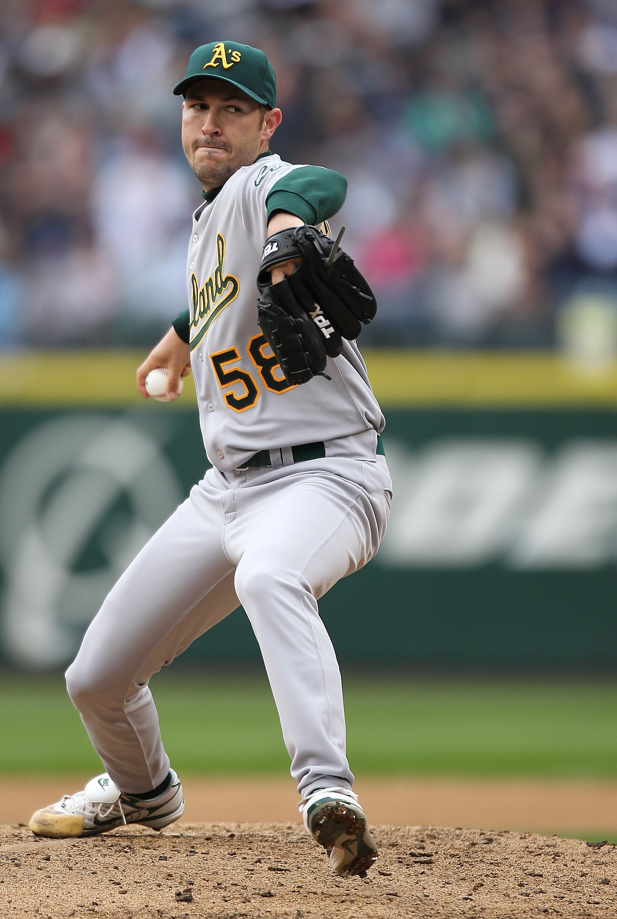 SEATTLE - APRIL 12:  Starting pitcher Justin Duchscherer #58 of the the Oakland Athletics pitches against the Seattle Mariners during the Mariners' home opener at Safeco Field on April 12, 2010 in Seattle, Washington. (Photo by Otto Greule Jr/Getty Images