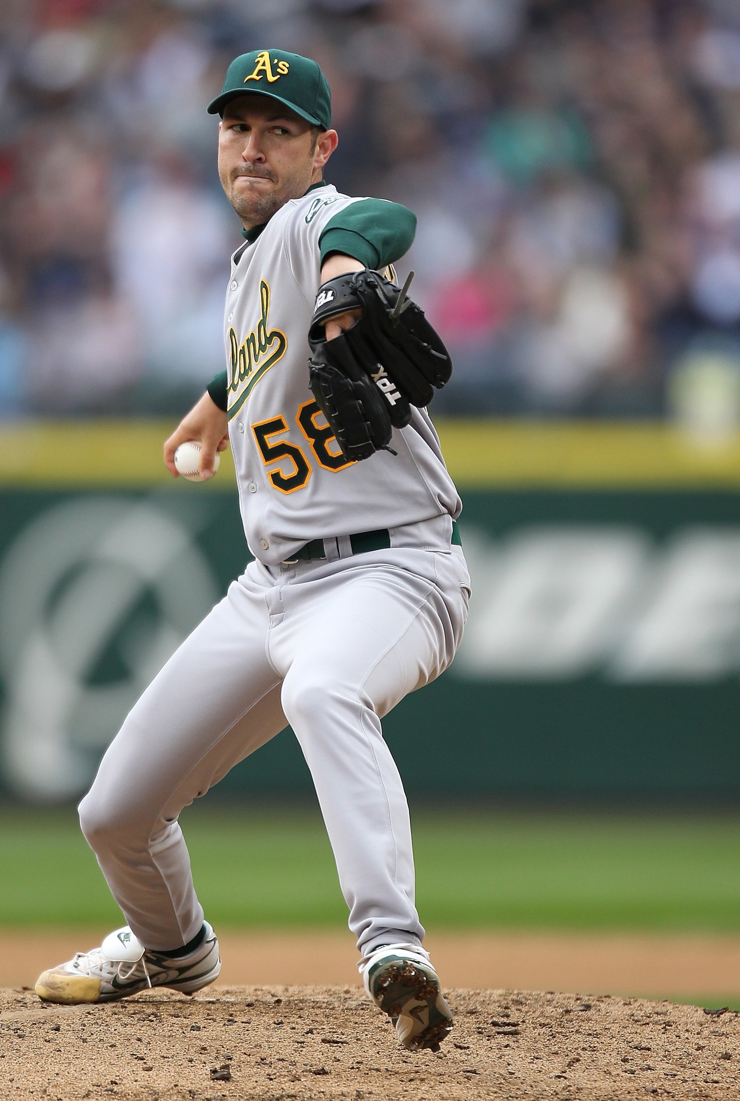 SEATTLE - APRIL 12:  Starting pitcher Justin Duchscherer #58 of the the Oakland Athletics pitches against the Seattle Mariners during the Mariners' home opener at Safeco Field on April 12, 2010 in Seattle, Washington. (Photo by Otto Greule Jr/Getty Images