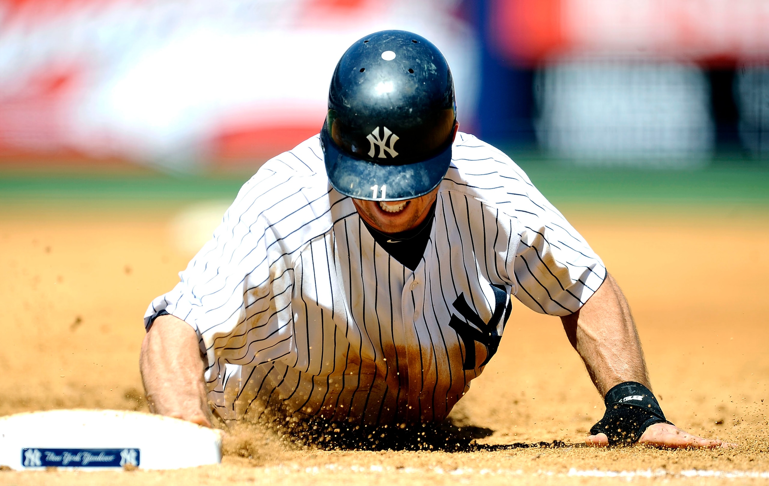 NEW YORK - MAY 05:  Brett Gardner #11 of the New York Yankees dives back to first against the Baltimore Orioles at Yankee Stadium on May 5, 2010 in the Bronx borough of New York City  (Photo by Jeff Zelevansky/Getty Images)