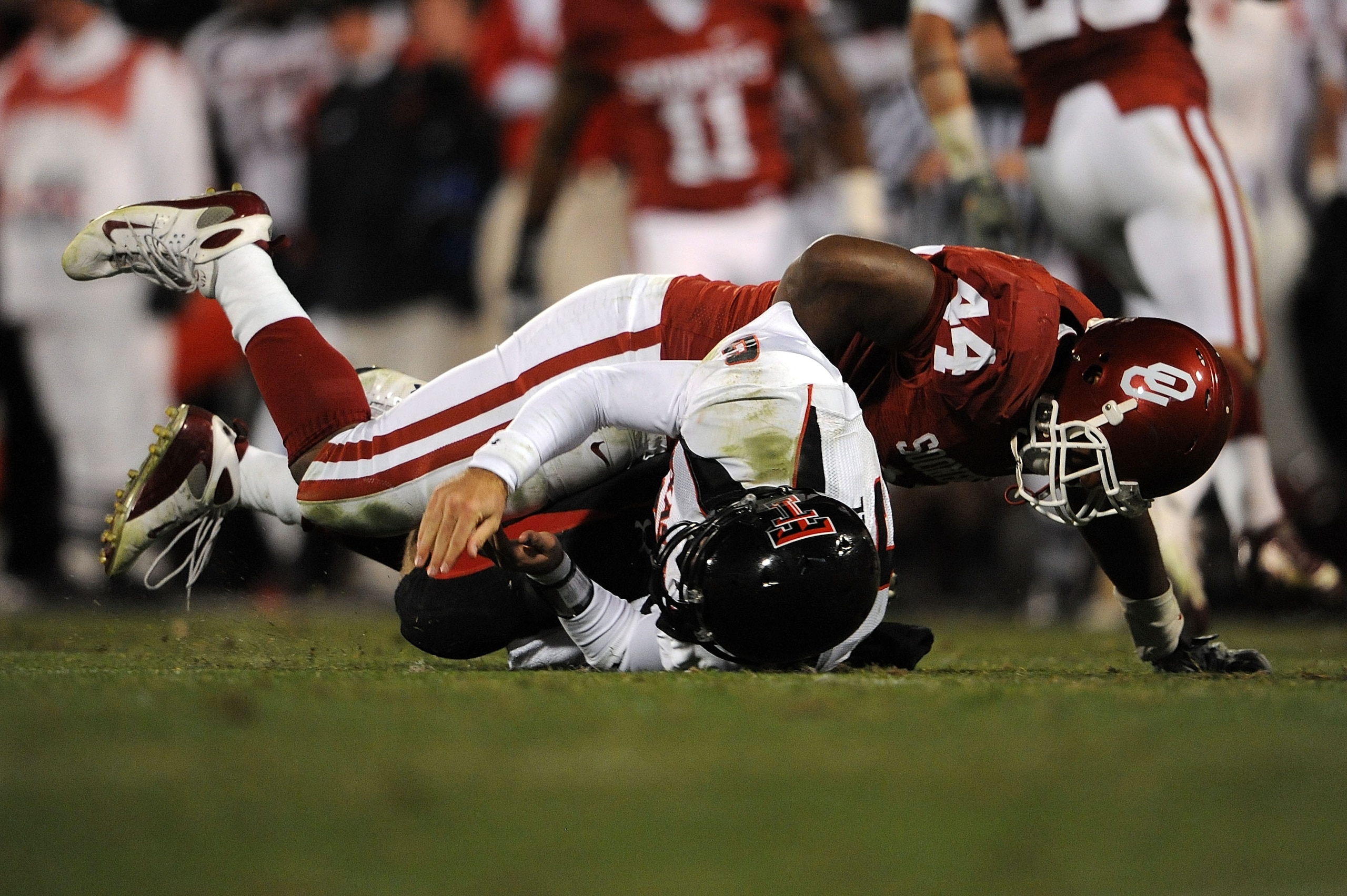 NORMAN, OK - NOVEMBER 22:  Quarterback Graham Harrell #6 of the Texas Tech Red Raiders is tackled by Jeremy Beal #44 of the Oklahoma Sooners at Memorial Stadium on November 22, 2008 in Norman, Oklahoma.  (Photo by Ronald Martinez/Getty Images)