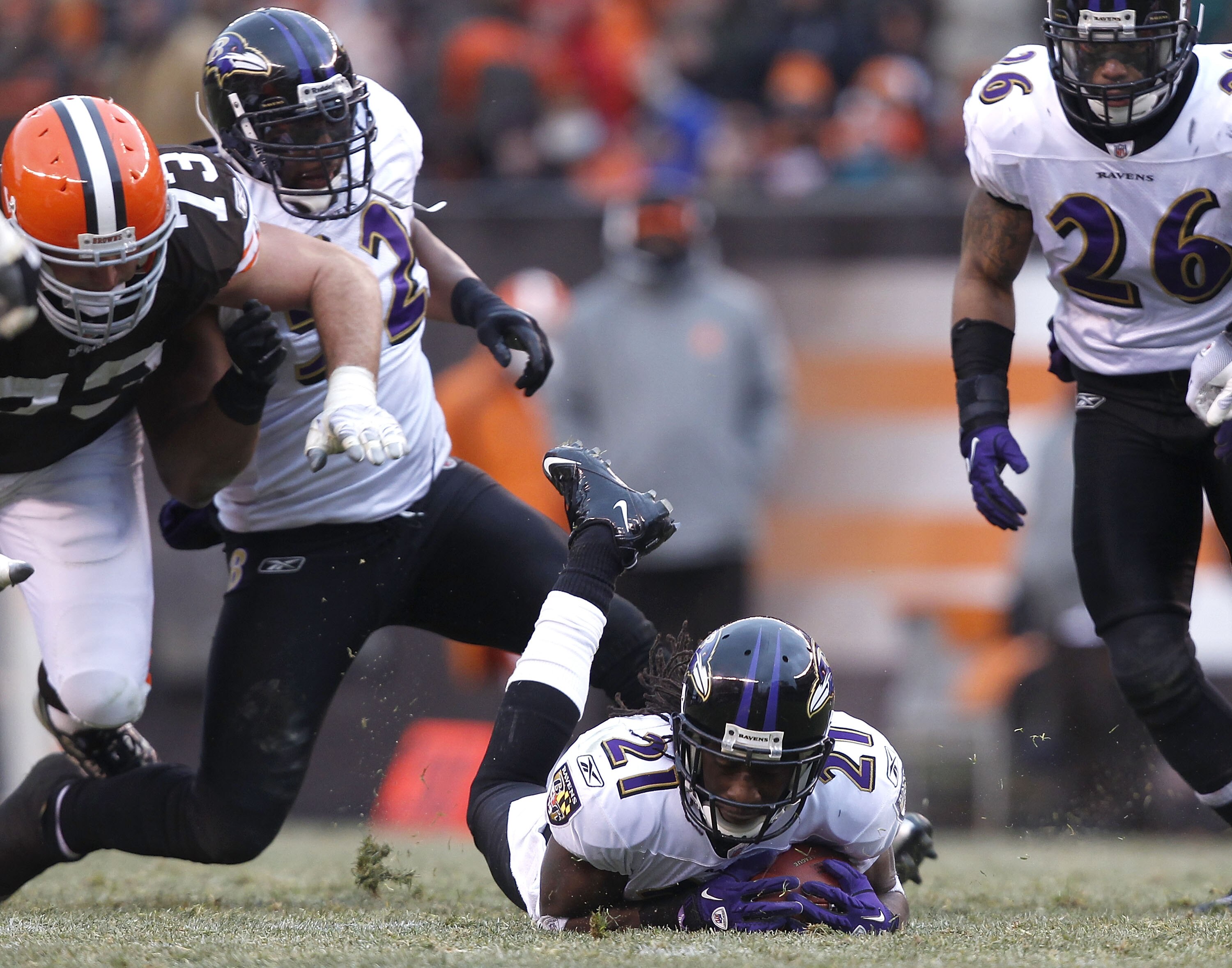 CLEVELAND - DECEMBER 26:  Cornerback Lardarius Webb #21 of the Baltimore Ravens recovers a fumble as Ray Lewis #52, Dawan Landry #26 and lineman Joe Thomas #73 of the Cleveland Browns look on at Cleveland Browns Stadium on December 26, 2010 in Cleveland,