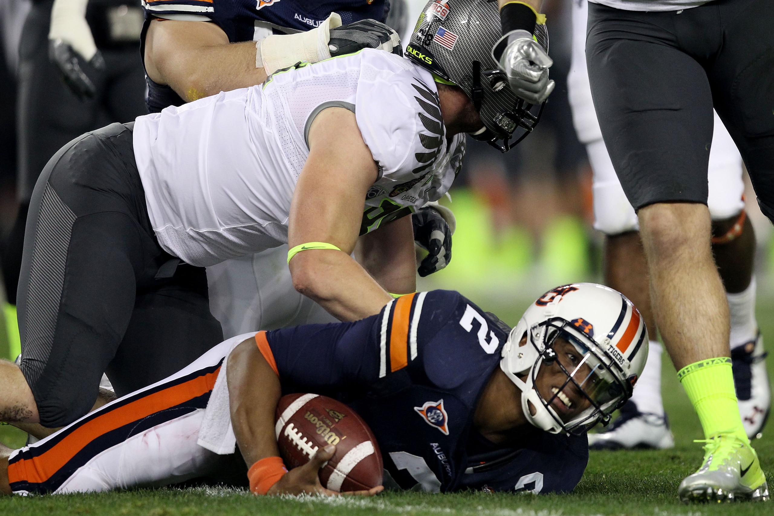 GLENDALE, AZ - JANUARY 10:  Quarterback Cameron Newton #2 of the Auburn Tigers gets up after being tacked in the first quarter against the Oregon Ducks during the Tostitos BCS National Championship Game at University of Phoenix Stadium on January 10, 2011