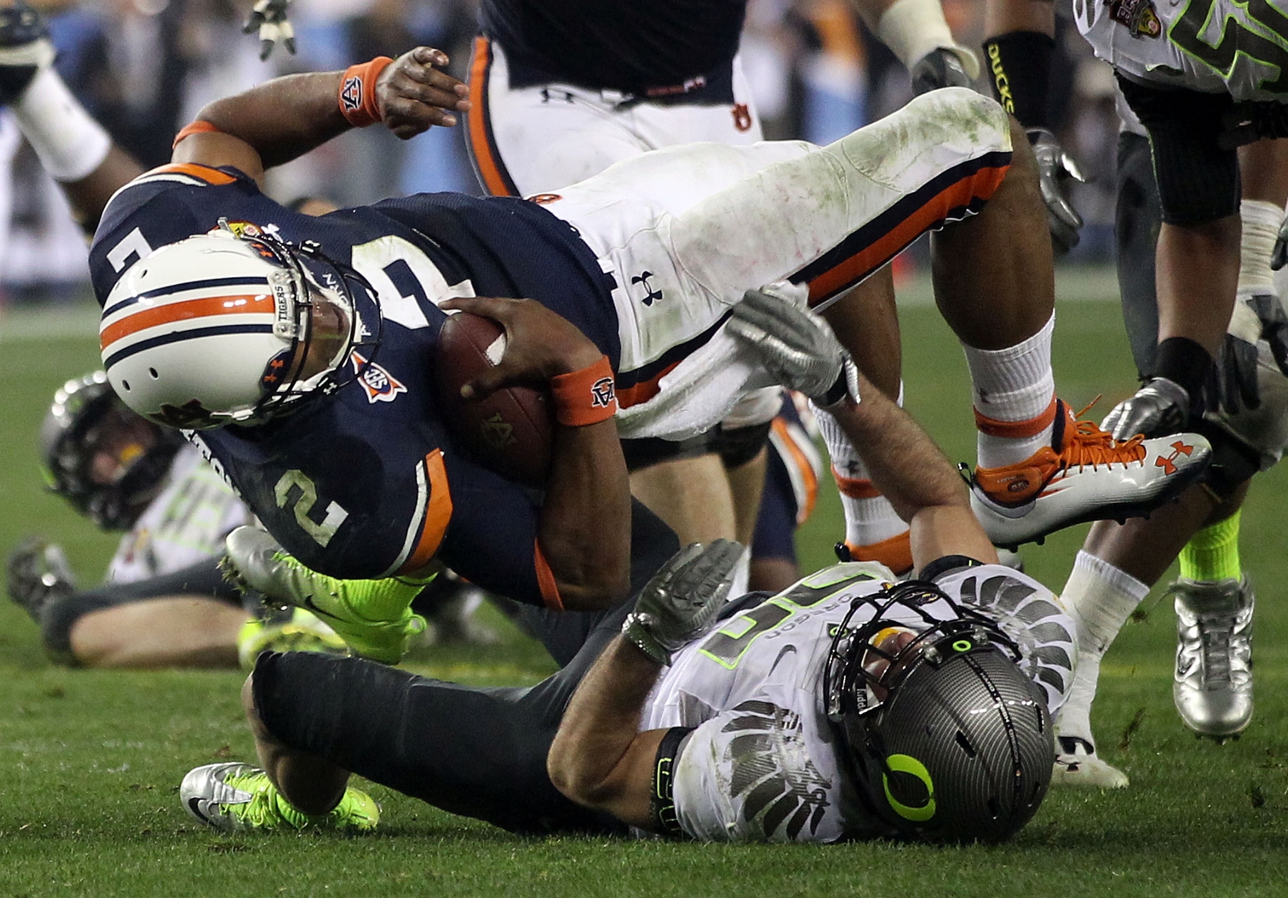 GLENDALE, AZ - JANUARY 10:  Cameron Newton #2 of the Auburn Tigers is brought down by John Boyett #20 of the Oregon Ducks during the Tostitos BCS National Championship Game at University of Phoenix Stadium on January 10, 2011 in Glendale, Arizona.  (Photo