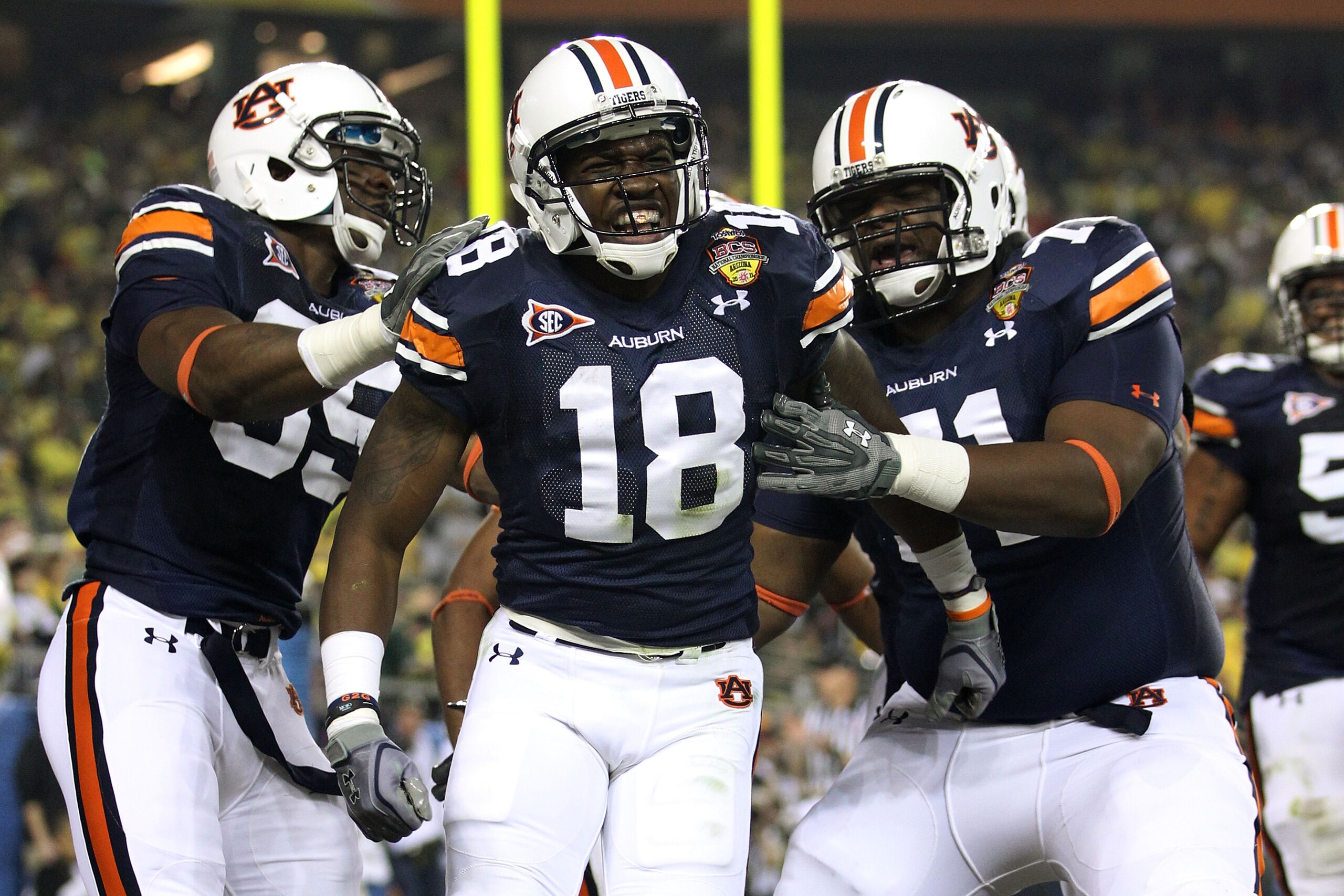 GLENDALE, AZ - JANUARY 10:  Wide receiver Kodi Burns #18 of the Auburn Tigers reacts with teammates after scoring on a 35-yard touchdown reception in the second quarter against the Oregon Ducks during the Tostitos BCS National Championship Game at Univers