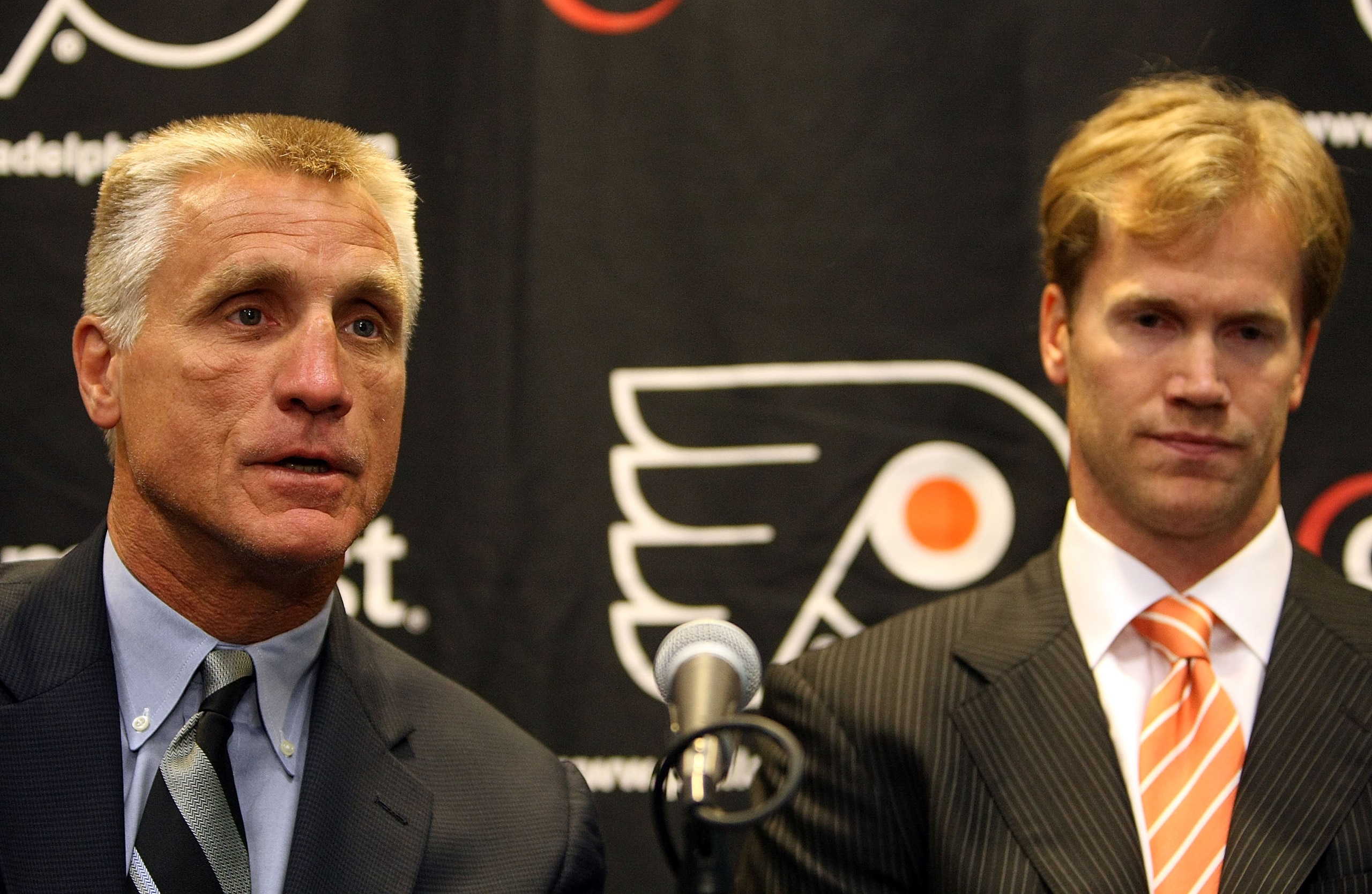 PHILADELPHIA - JULY 06: (L-R) Flyers General Manager, Paul Holmgren and Chris Pronger #20 of the Philadelphia Flyers talk with the media during his first press conference as a Philadelphia Flyer at Flyer's Skate Zone on July 6, 2009 in Philadelphia, Penns