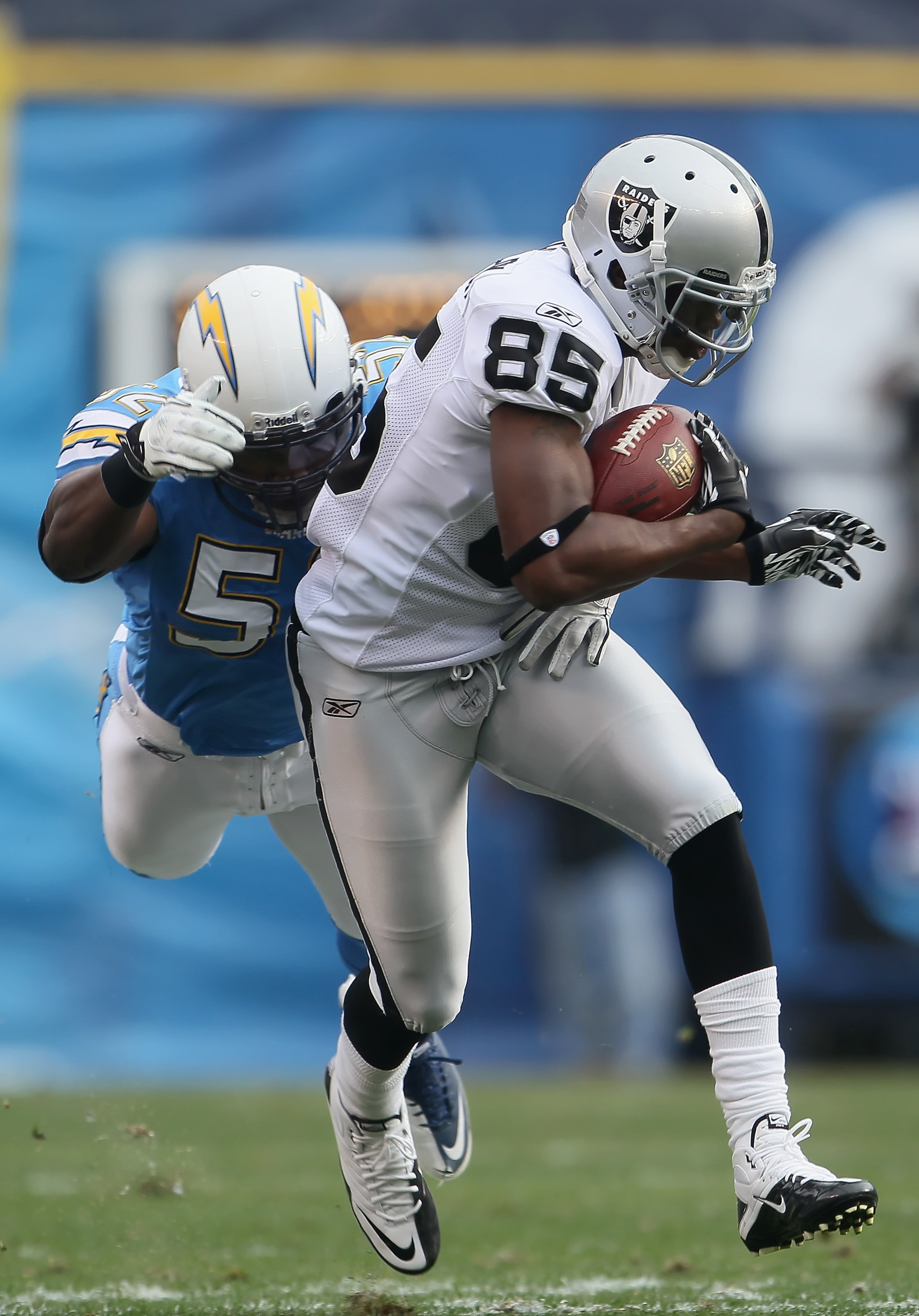 SAN DIEGO - DECEMBER 05:  Darrius Heyward-Bey #85 of the Oakland Raiders is tackled by Larry English #52 of the San Diego Chargers in the second quarter at Qualcomm Stadium on December 5, 2010 in San Diego, California. The Raiders defeated the Chargers 28