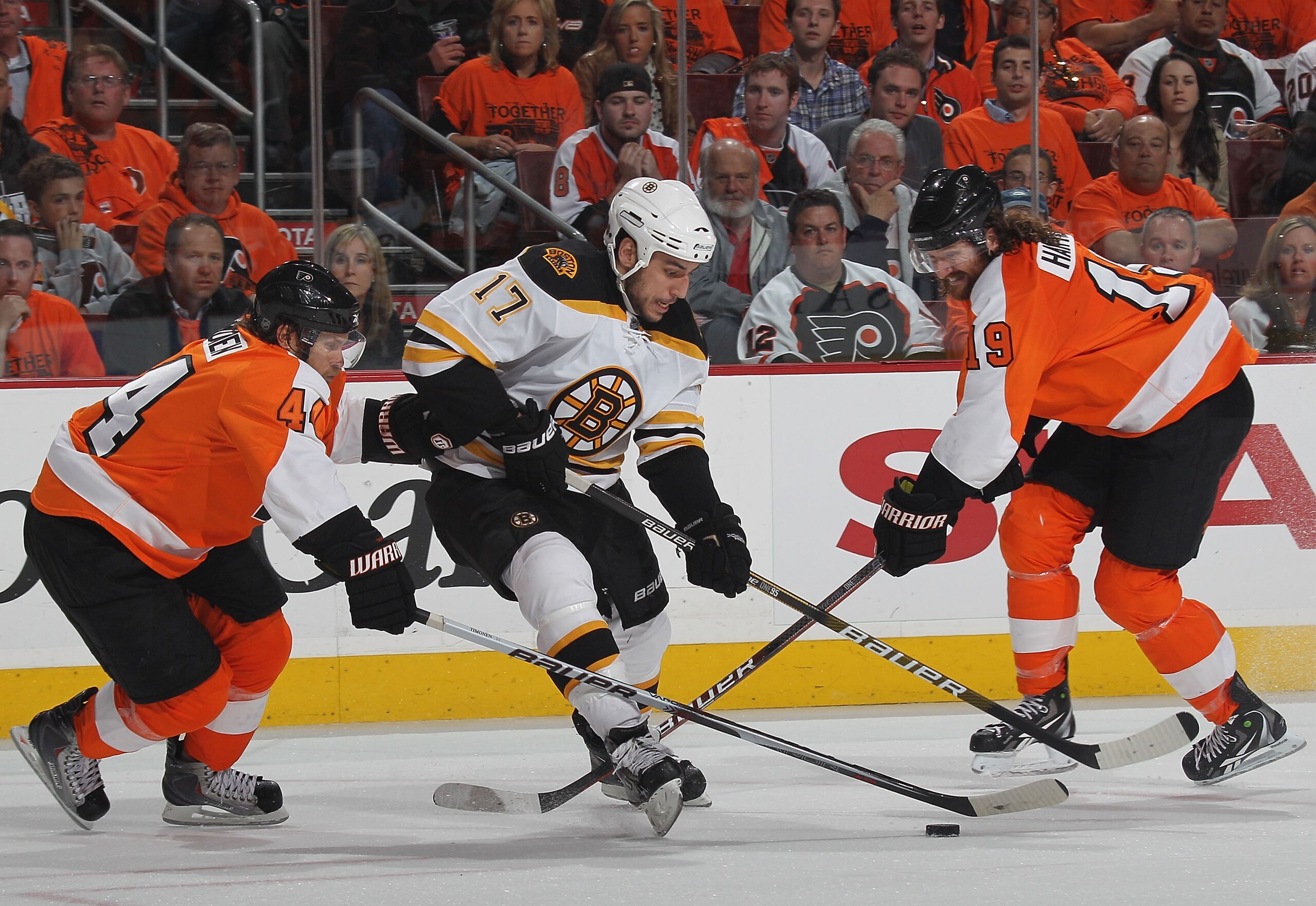 PHILADELPHIA - MAY 12: Milan Lucic #17 of the Boston Bruins skates around Kimmo Timonen #44 and Scott Hartnell #19 of the Philadelphia Flyers in Game Six of the Eastern Conference Semifinals during the 2010 NHL Stanley Cup Finals at the Wachovia Center on