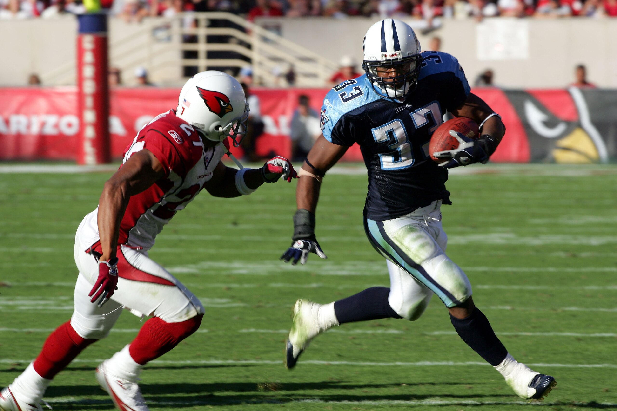 TEMPE, AZ - OCTOBER 23:  Running back Jarrett Payton #33 of the Tennessee Titans tries to get around David Macklin #27 of the Arizona Cardinals during the fourth quarter at Sun Devil Stadium on October 23, 2005 in Tempe, Arizona. The Cardinals defeated th