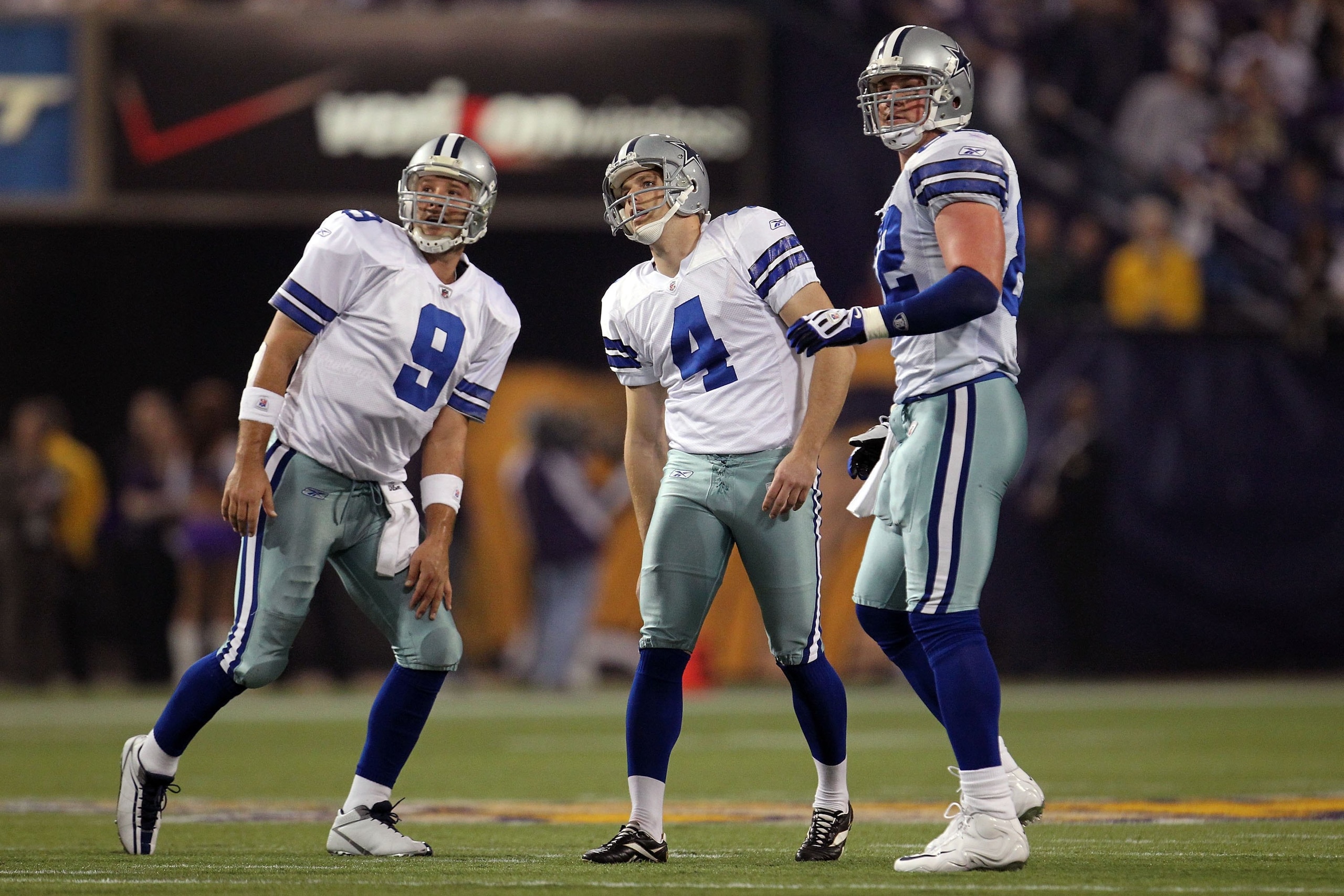 MINNEAPOLIS - JANUARY 17:  Quarterback Tony Romo #9, Shaun Suisham #4 and Jason Witten #82 of the Dallas Cowboys look on while playing against the Minnesota Vikings during the NFC Divisional Playoff Game at Hubert H. Humphrey Metrodome on January 17, 2010