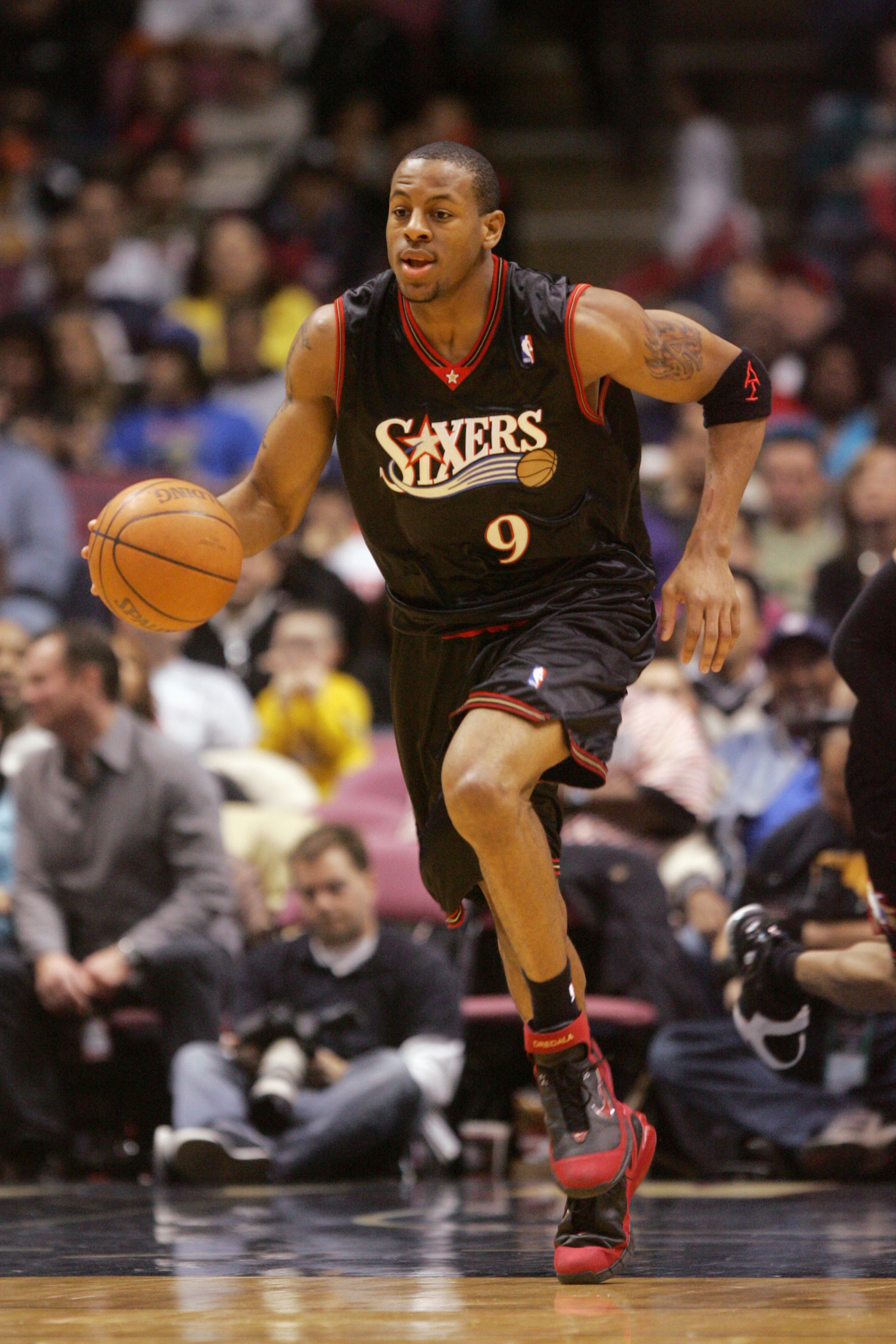 EAST RUTHERFORD, NJ - DECEMBER 10:  Andre Iguodala  #9 of the Philadelphia 76ers moves the ball up court during a game against the New Jersey Nets at Continental Airlines Arena on December 10, 2005 in East Rutherford, New Jersey.  The Sixers defeated the