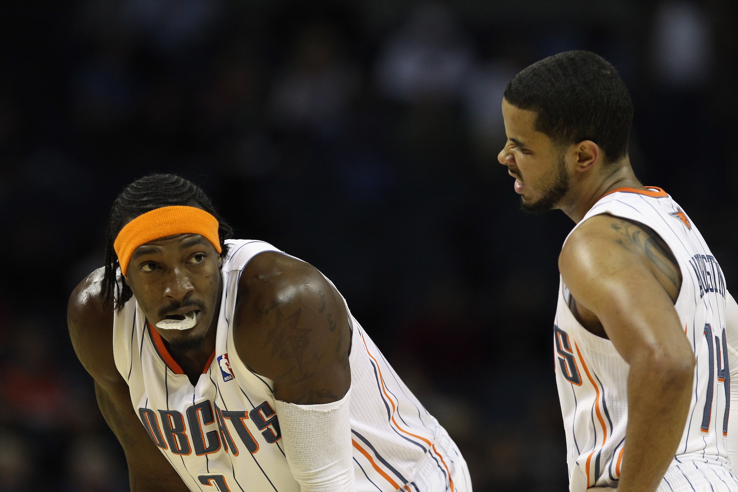 CHARLOTTE, NC - NOVEMBER 08:  Teammates Gerald Wallace #3 and D.J. Augustin #14 of the Charlotte Bobcats react as they wait during their game against the San Antonio Spurs at Time Warner Cable Arena on November 8, 2010 in Charlotte, North Carolina.  NOTE