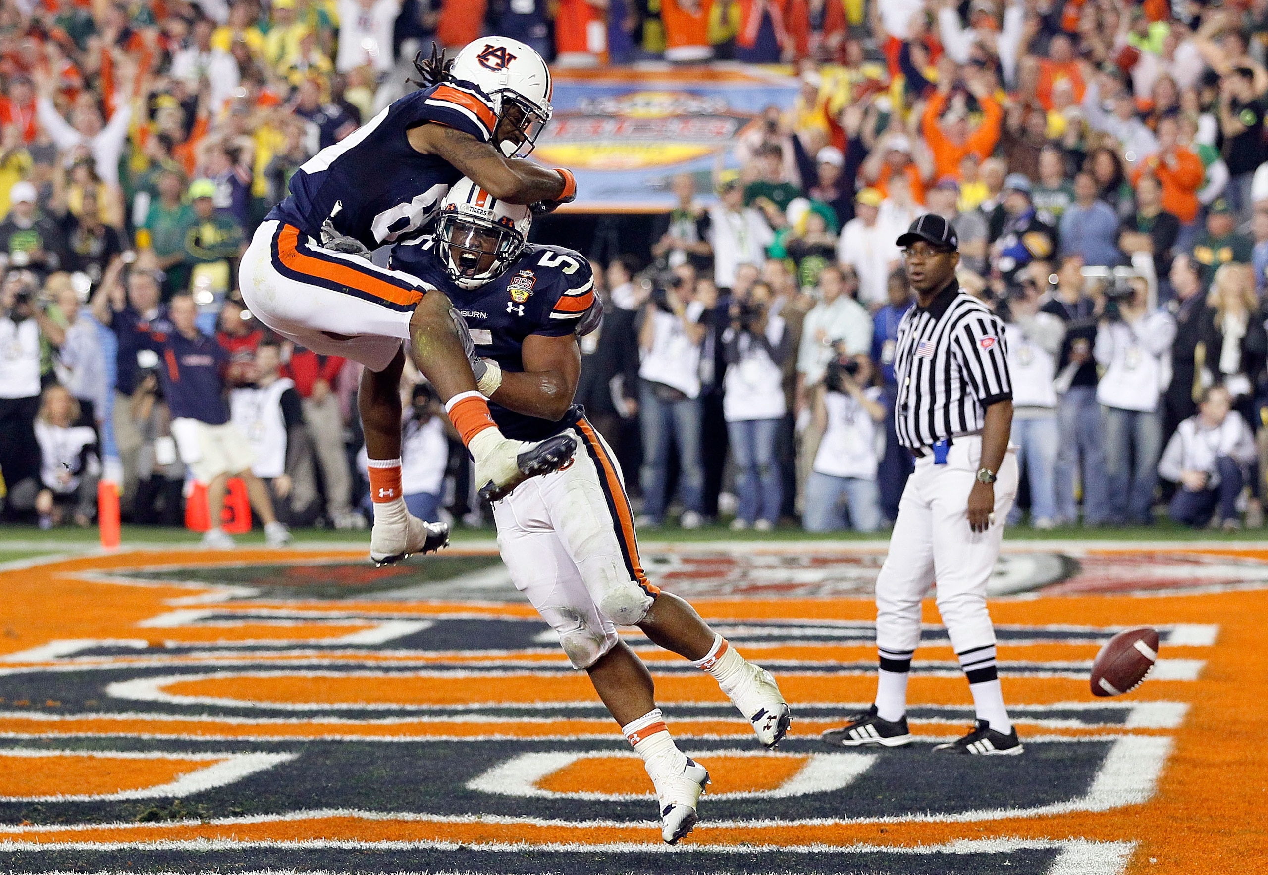 GLENDALE, AZ - JANUARY 10:  Michael Dyer #5 of the Auburn Tigers celebrates with Darvin Adams #89 Tigers after Dyer runs the ball for 16-yards and is called down at the one-yardline with 10 seconds remaining in the fourth quarter against the Oregon Ducks