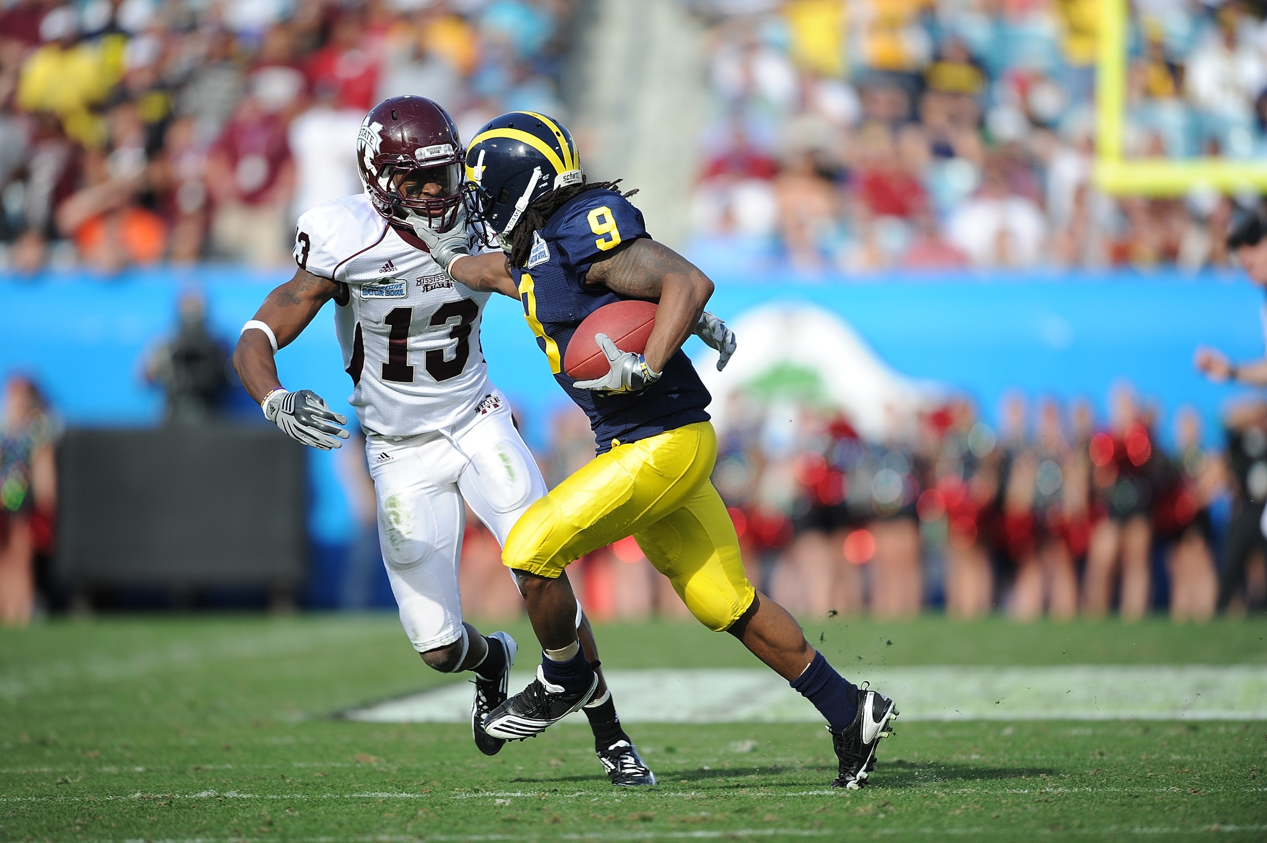 JACKSONVILLE, FL - JANUARY 01:  Martavious Odoms #9 of the Michigan Wolverines is tackled by Johnthan Banks of #13 of the Mississippi State Bulldogs during the Gator Bowl at EverBank Field on January 1, 2011 in Jacksonville, Florida  (Photo by Rick Dole/G