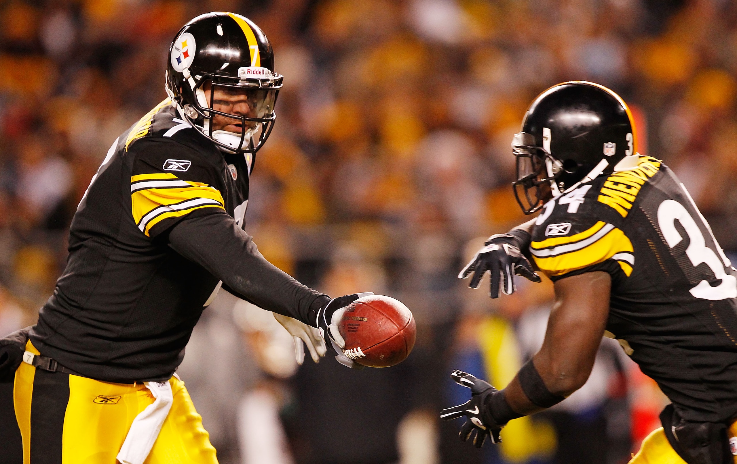 PITTSBURGH - DECEMBER 23:  Ben Roethlisberger #7 of the Pittsburgh Steelers hands the ball off to teammate Rashard Mendenhall #34 during the game against  the Carolina Panthers on December 23, 2010 at Heinz Field in Pittsburgh, Pennsylvania.  (Photo by Ja