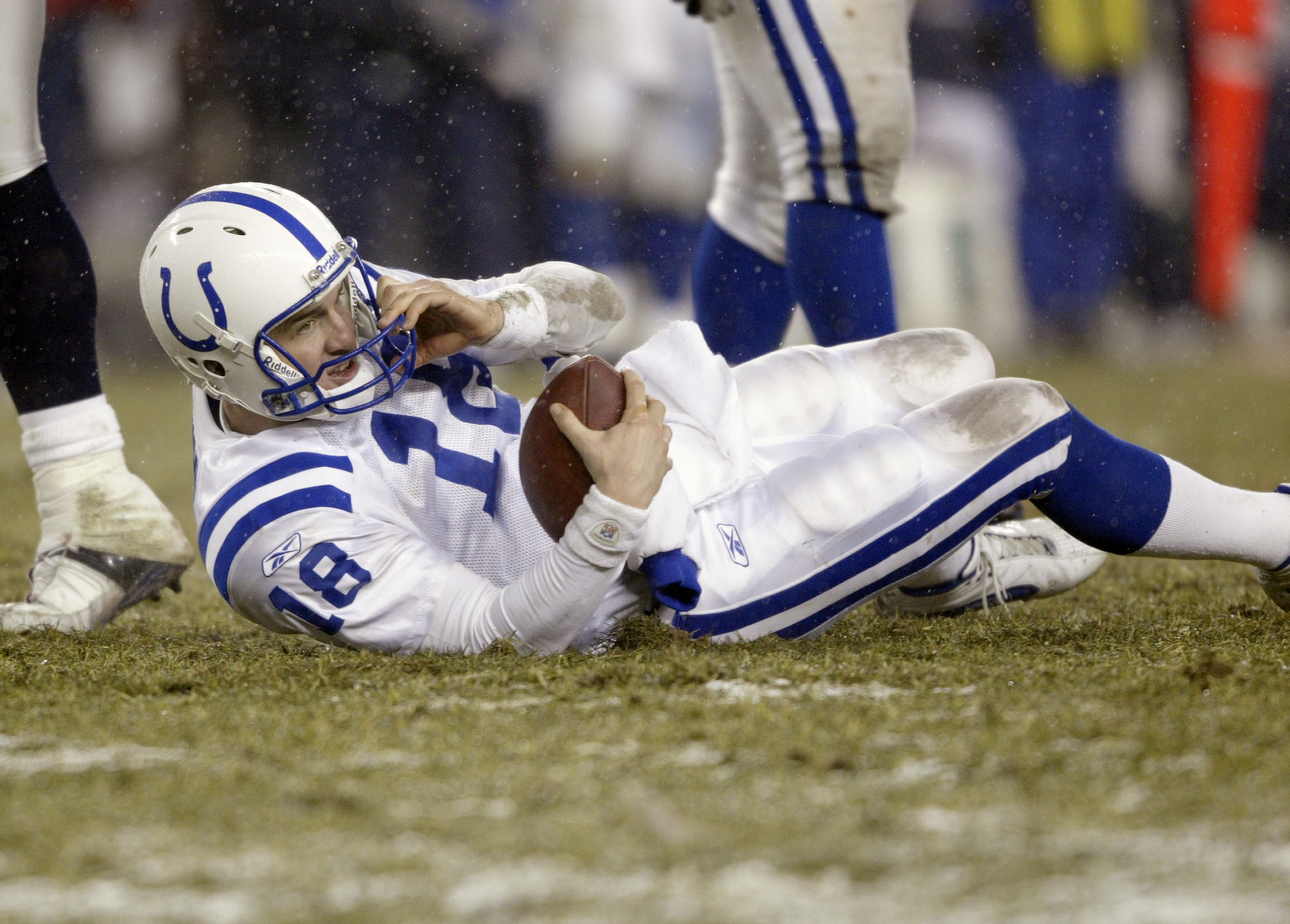 FOXBORO, MA - JANUARY 18:  Quaterback Peyton Manning #18 of the Indianapolis Colts grips the ball after being sacked during the AFC Championship Game against the New England Patriots on January 18, 2004 at Gillette Stadium in Foxboro, Massachusetts. The P