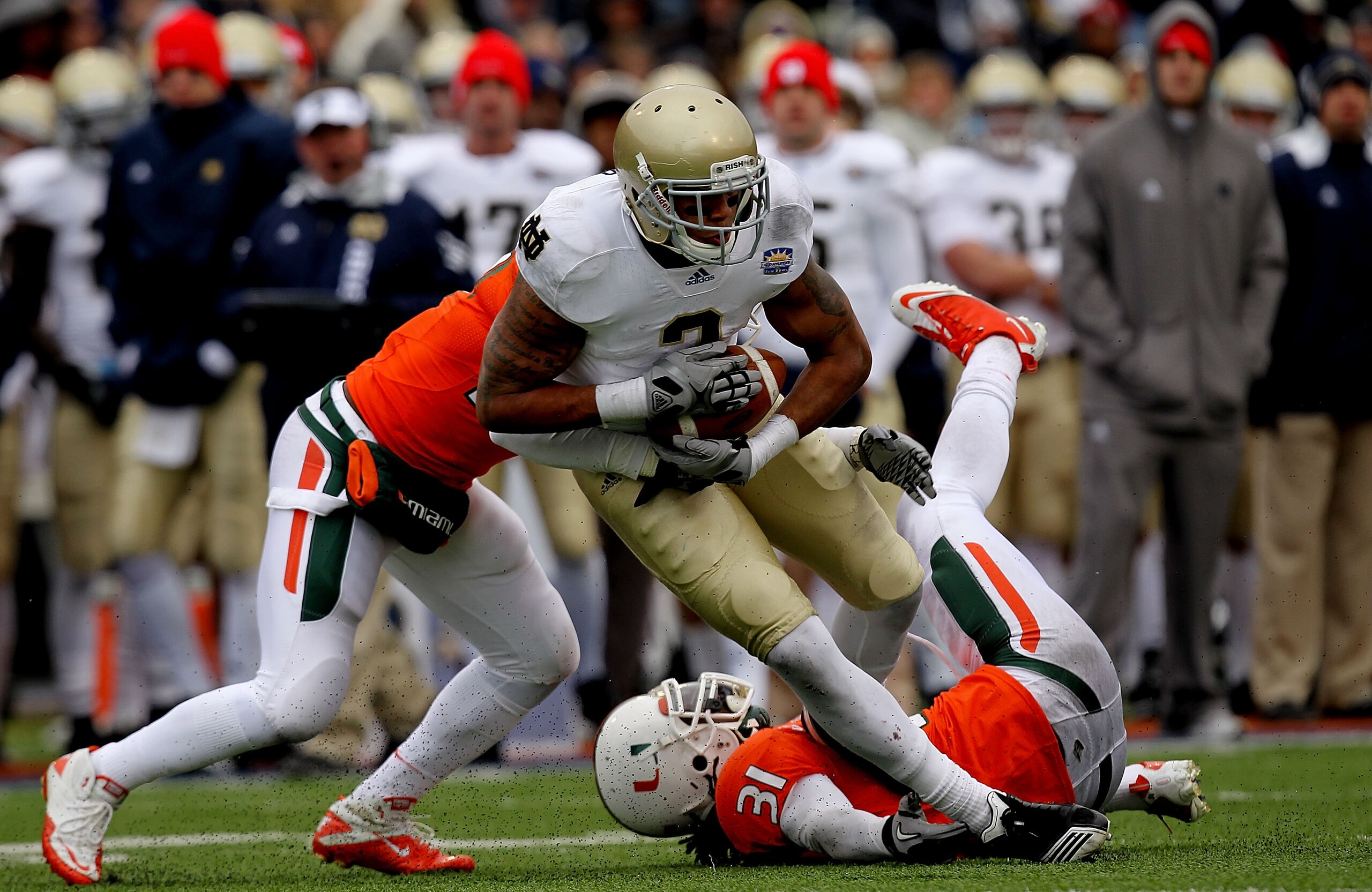 EL PASO, TX - DECEMBER 30: Wide receiver Michael Floyd #3 of the Notre Dame Fighting Irish runs the ball past Jared Campbell #37 and Sean Spence #31 of the Miami Hurricanes at Sun Bowl on December 30, 2010 in El Paso, Texas. (Photo by Ronald Martinez/Ge EL PASO, TX - DECEMBER 30: Wide receiver Michael Floyd #3 of the Notre Dame Fighting Irish runs the ball past Jared Campbell #37 and Sean Spence #31 of the Miami Hurricanes at Sun Bowl on December 30, 2010 in El Paso, Texas. (Photo by Ronald Martinez/Ge