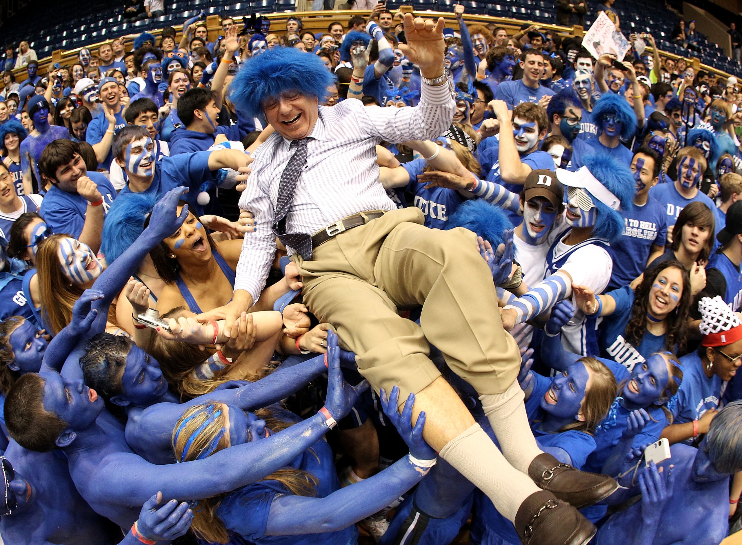 DURHAM, NC - MARCH 06:  ESPN analyst Dick Vitale surfs the crowd with the Cameron Crazies before the start of the game between the North Carolina Tar Heels and Duke Blue Devils at Cameron Indoor Stadium on March 6, 2010 in Durham, North Carolina.  (Photo