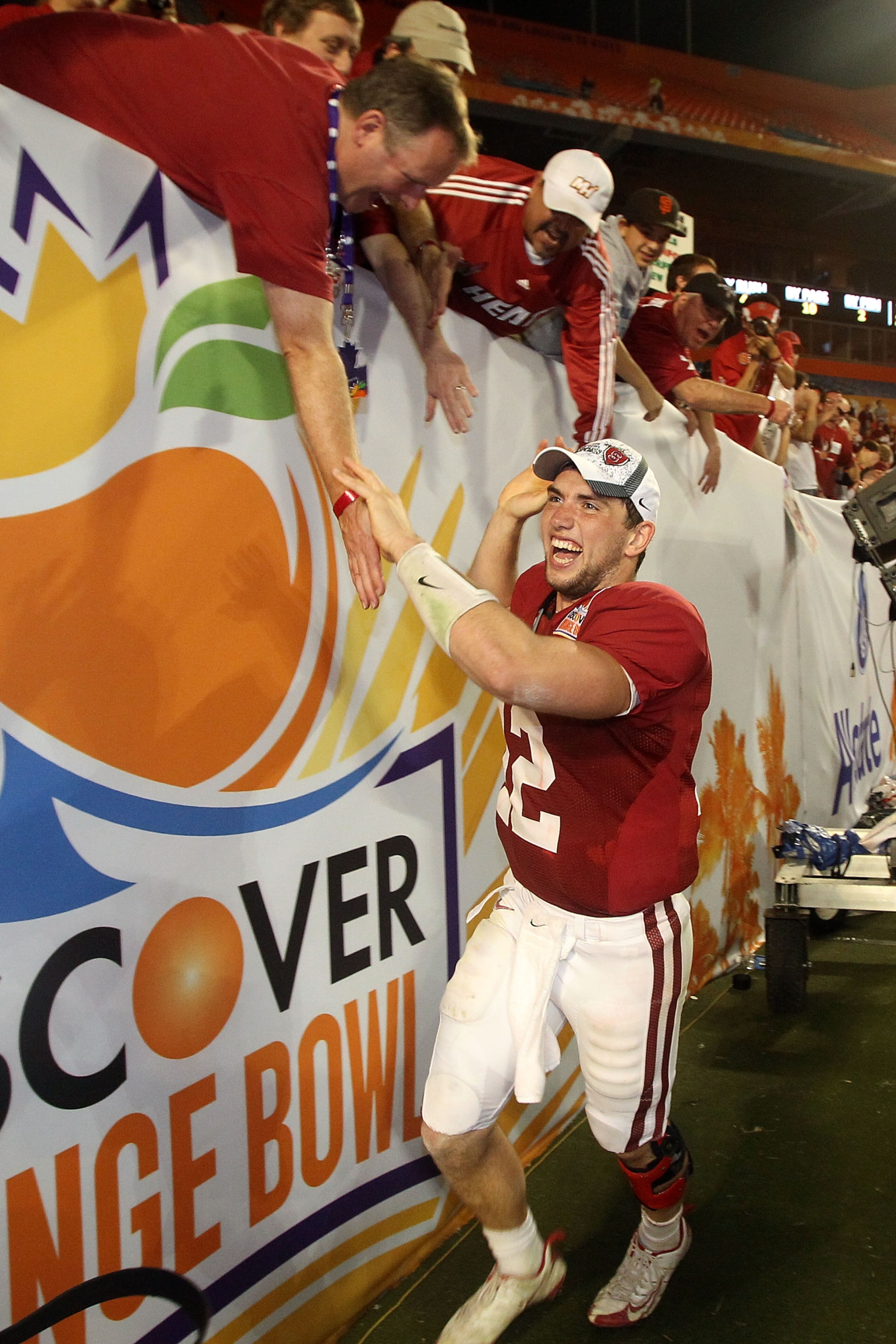 MIAMI, FL - JANUARY 03: Orange Bowl MVP Andrew Luck of the Stanford Cardinal celebrates with fans after Stanford won 40-14 against the Virginia Tech Hokies during the 2011 Discover Orange Bowl at Sun Life Stadium on January 3, 2011 in Miami, Florida. (P MIAMI, FL - JANUARY 03: Orange Bowl MVP Andrew Luck of the Stanford Cardinal celebrates with fans after Stanford won 40-14 against the Virginia Tech Hokies during the 2011 Discover Orange Bowl at Sun Life Stadium on January 3, 2011 in Miami, Florida. (P
