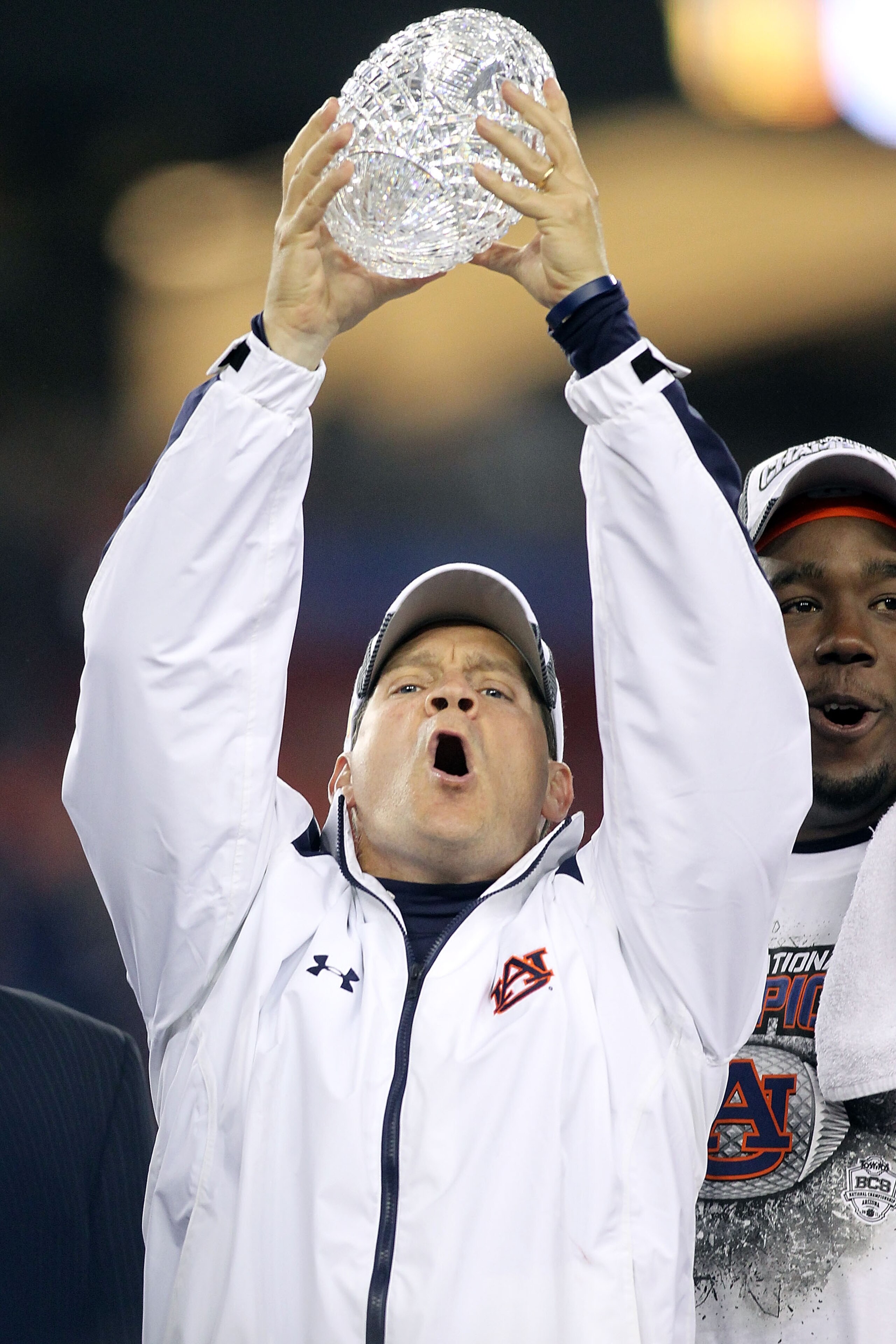 GLENDALE, AZ - JANUARY 10:  Head coach Gene Chizik of the Auburn Tigers celebrates the Tigers 22-19 victory as he holds up the Coaches Trophy after defeating the Oregon Ducks during the Tostitos BCS National Championship Game at University of Phoenix Stad