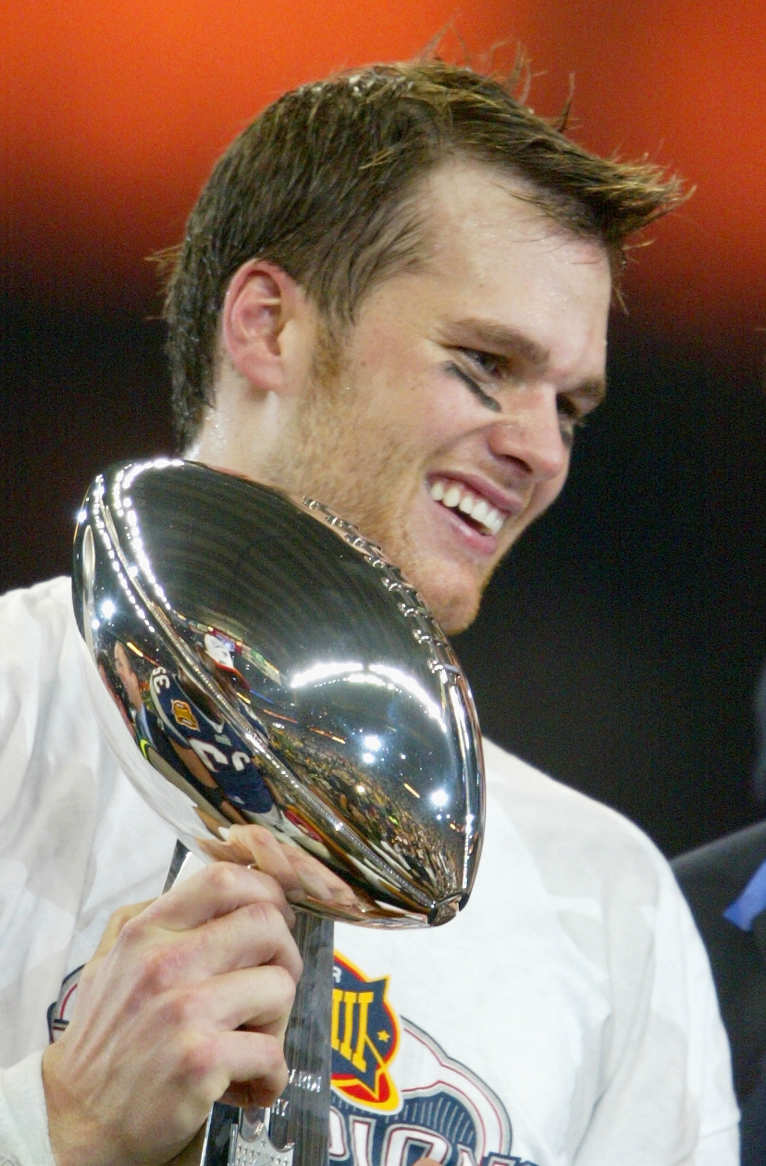 HOUSTON, TX - FEBRUARY 1:  MVP Tom Brady #12 of the New England Patriots holds the Lombardi trophy after defeating the Carolina Panthers 32-29 in Super Bowl XXXVIII at Reliant Stadium on February 1, 2004 in Houston, Texas. (Photo by Andy Lyons/Getty Image