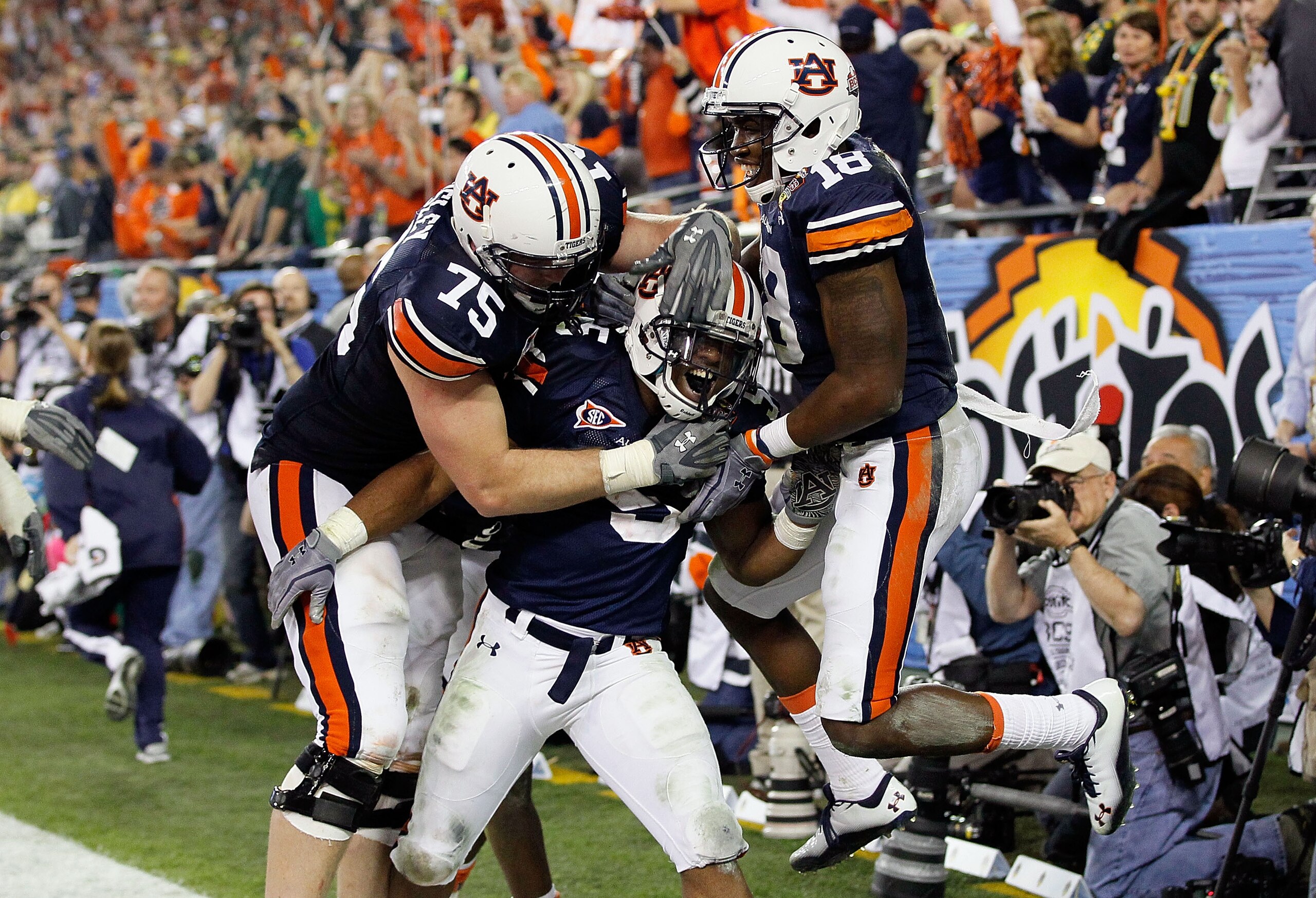 GLENDALE, AZ - JANUARY 10:  (C) Michael Dyer #5 of the Auburn Tigers celebrates with teammates after he runs the ball for 16-yards and is called down at the one-yardline with 10 seconds remaining in the fourth quarter against the Oregon Ducks during the T