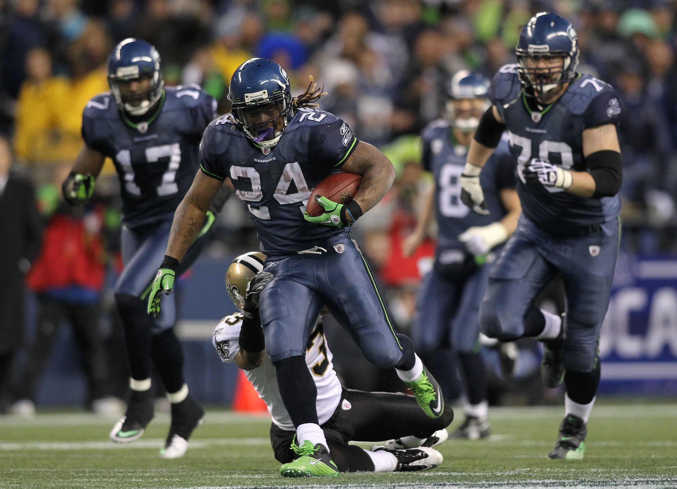 SEATTLE, WA - JANUARY 08:  Running back Marshawn Lynch #24 of the Seattle Seahawks runs for a 67-yard touchdown run in the fourth quarter against the New Orleans Saints during the 2011 NFC wild-card playoff game at Qwest Field on January 8, 2011 in Seattl